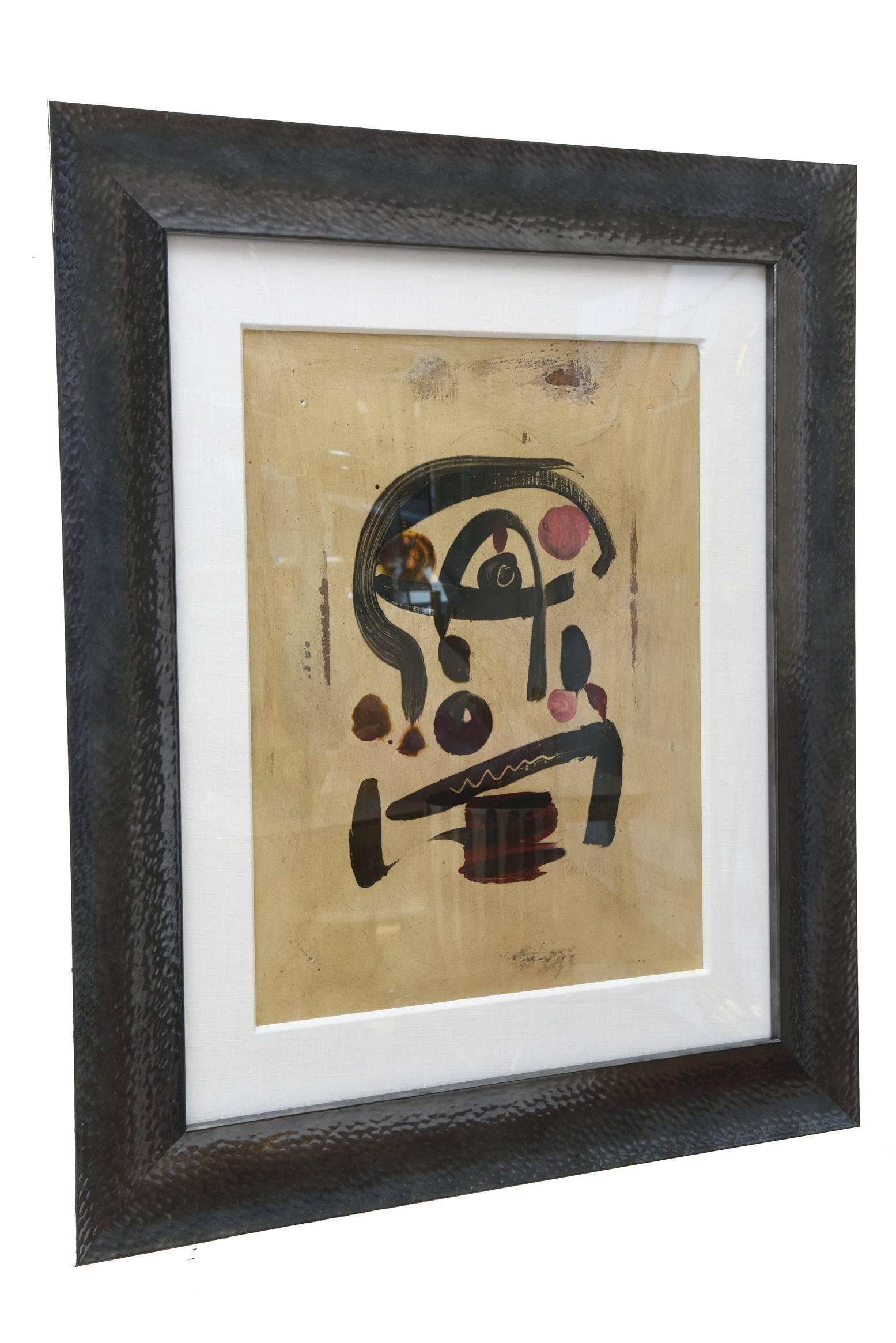 This wonderful abstract vintage painting has influences of Miro and his painterly strokes and gestures of paint in abstract form. The background is tan with stokes of black dark gray and elements of subdued red. It also has influences to the Art