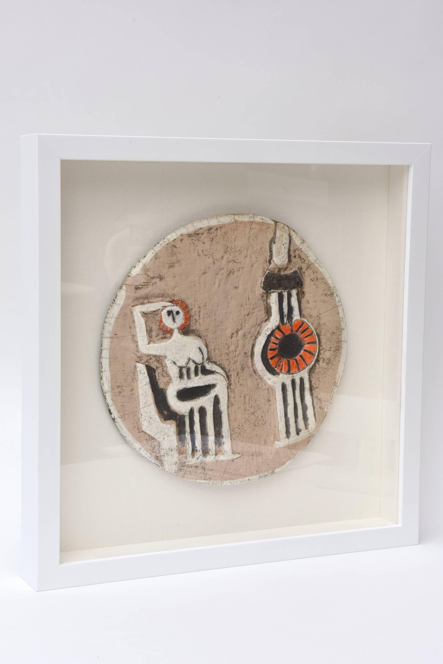 This wonderful studio ceramic disk plate sculpture was done in the 1970s by a Miami professor of the University of the Arts. It is signed but unfortunately illegible. It has the influence of Alfredo Lam meets Picasso. It is obvious that these two