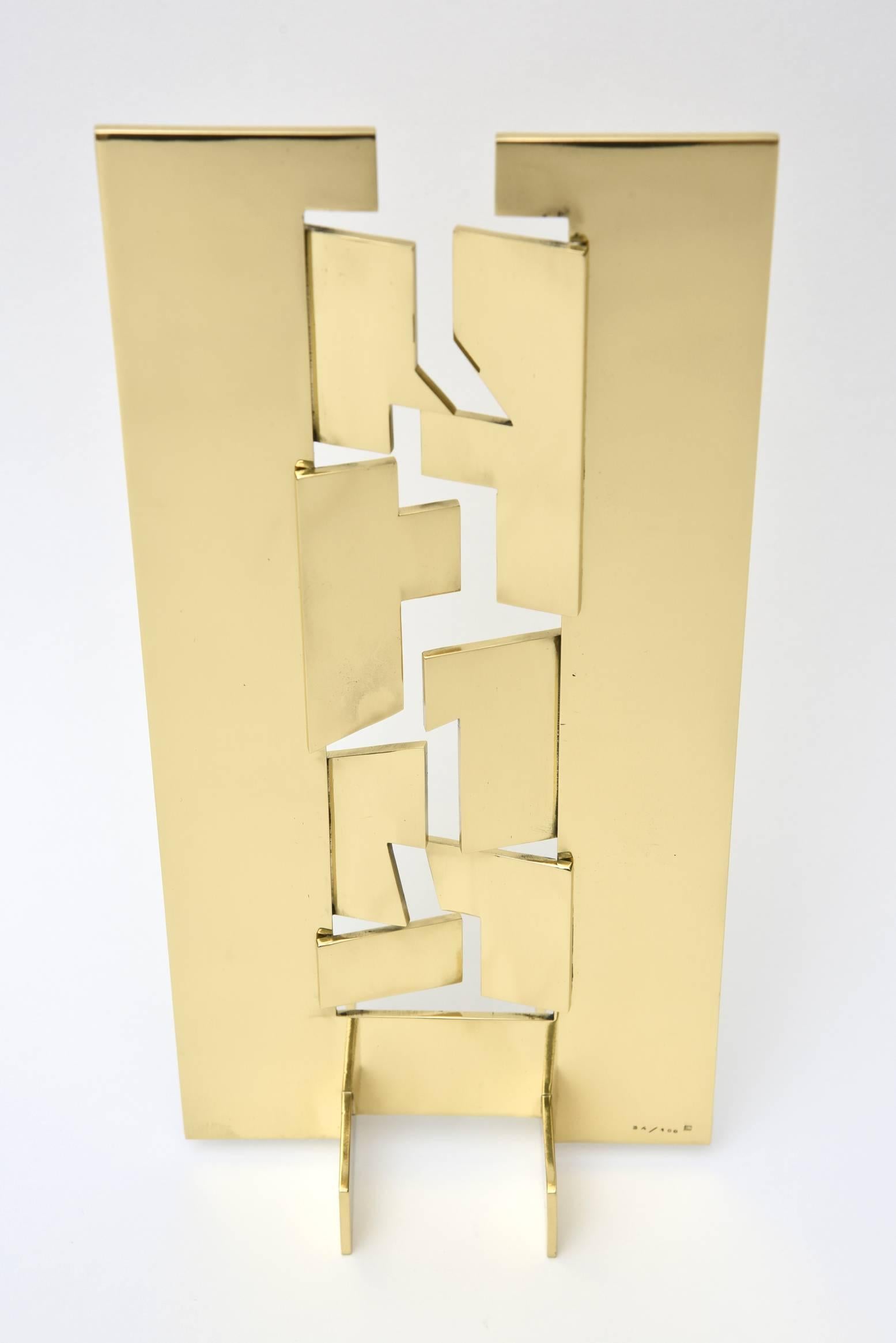This wonderful cut-out planes of brass make up the center of this modernist  and minimalist cascading tabletop sculpture by Francesco Maarino di Teanna. It is signed MOT and the edition is 34/100 as shown in the photos.  This is the artist's
