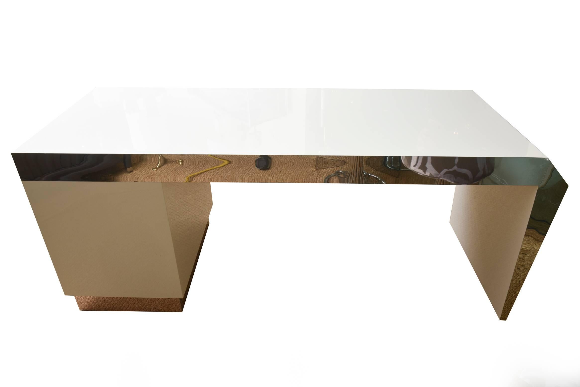 This very heavy and monumental fully restored white lacquered and stainless steel amazing desk is sculptural. It has drawers on the right hand side and one middle desk drawer. Stainless steel wrapping is on the front apron, the back, the bottom and