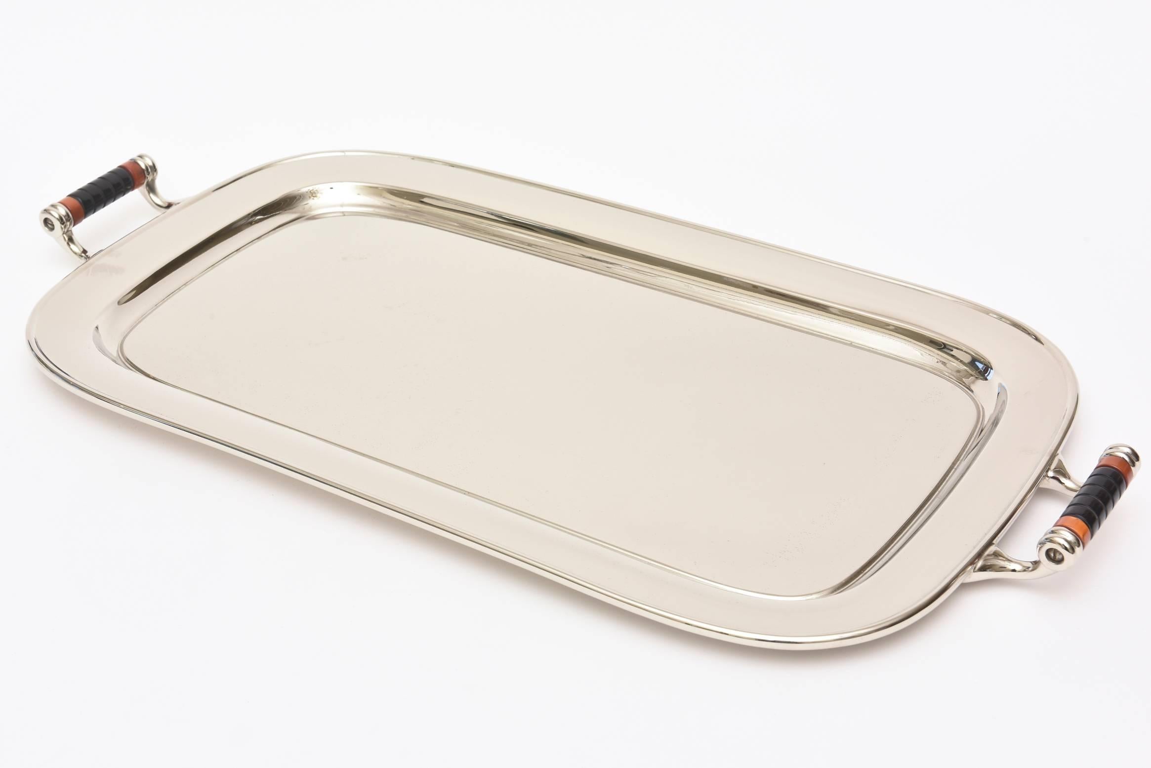 This very versatile two handled vintage Art Deco rectangular nickel silver over chrome and aluminum bar or serving tray is so handsome. It is marked on the back Manning Bowman & Co. Meriden, Conn. The original Bakelite wrapped handles are amazing.