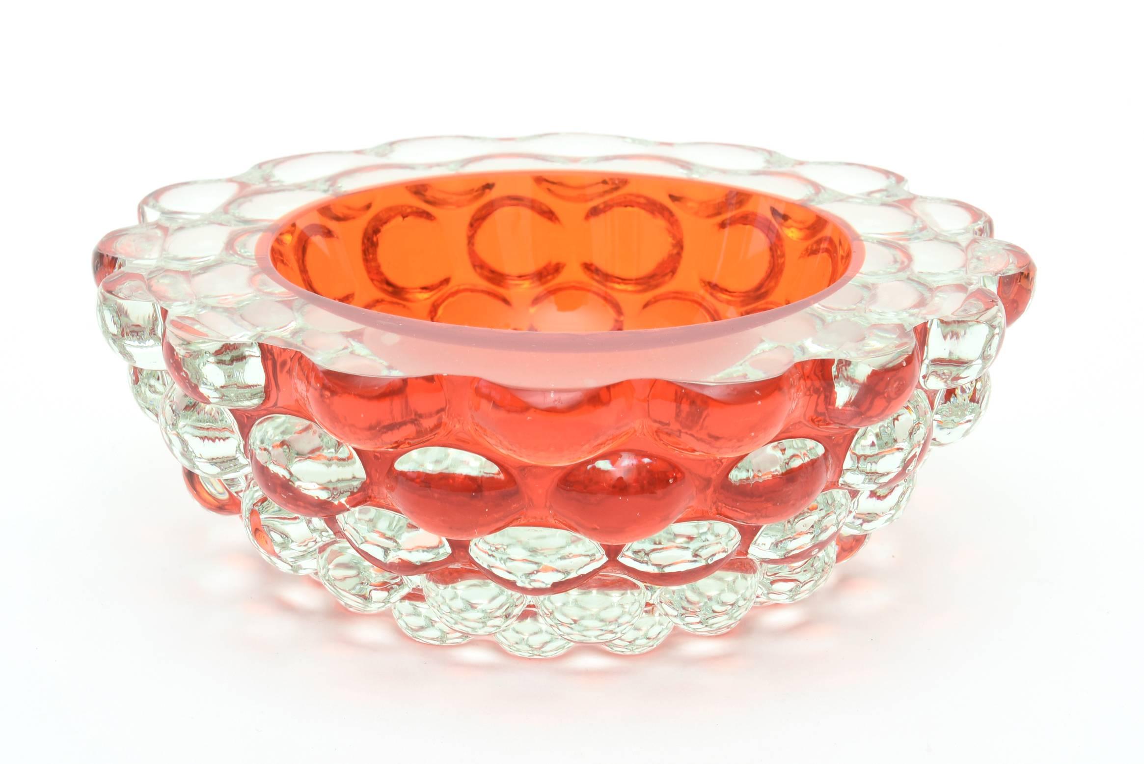 This luscious Italian Murano Sommerso bowl is by the company of G. Campanella and the interior color is Hermes orange in Sommerso layering.
It is almost like an orange bowl has been dropped in the center and you wish to lift it off; it creates an