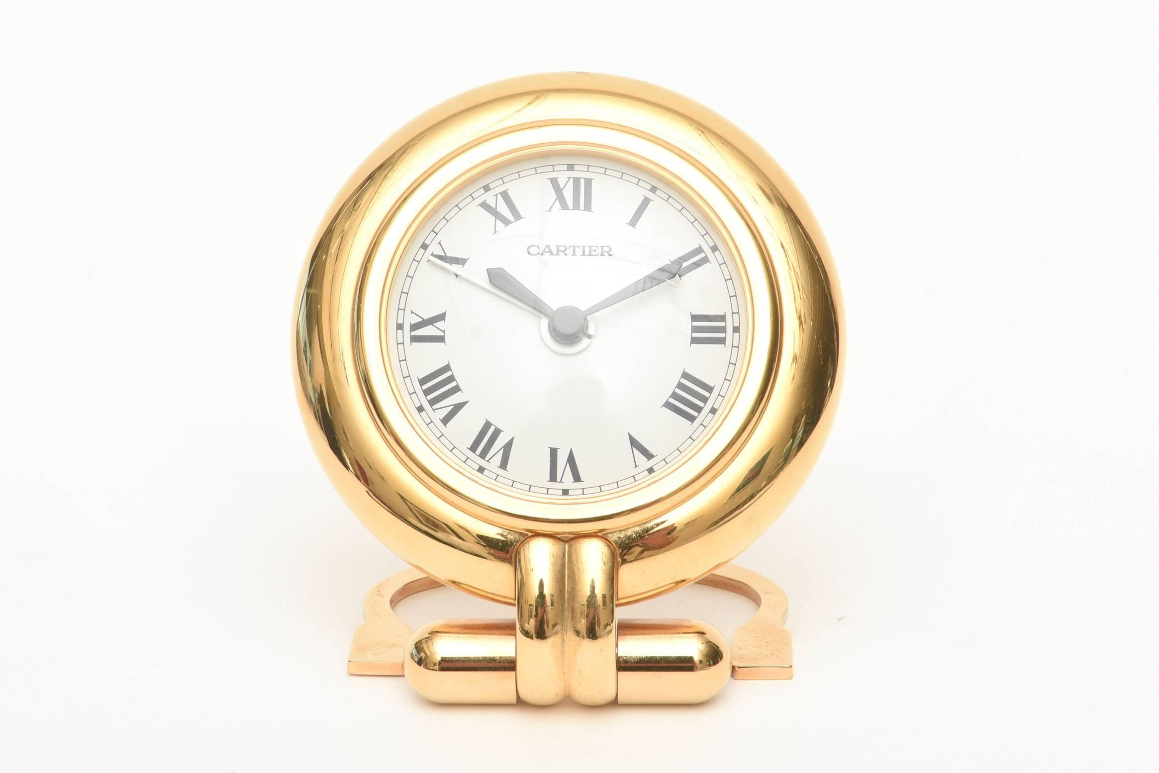 This stunning and elegant vintage Cartier quartz desk, travel or nightstand small fold up Roman numeral clock has its original box, certificate and papers. It is called the Colisee Clock collection and is 24 karat gold plated. It folds up for