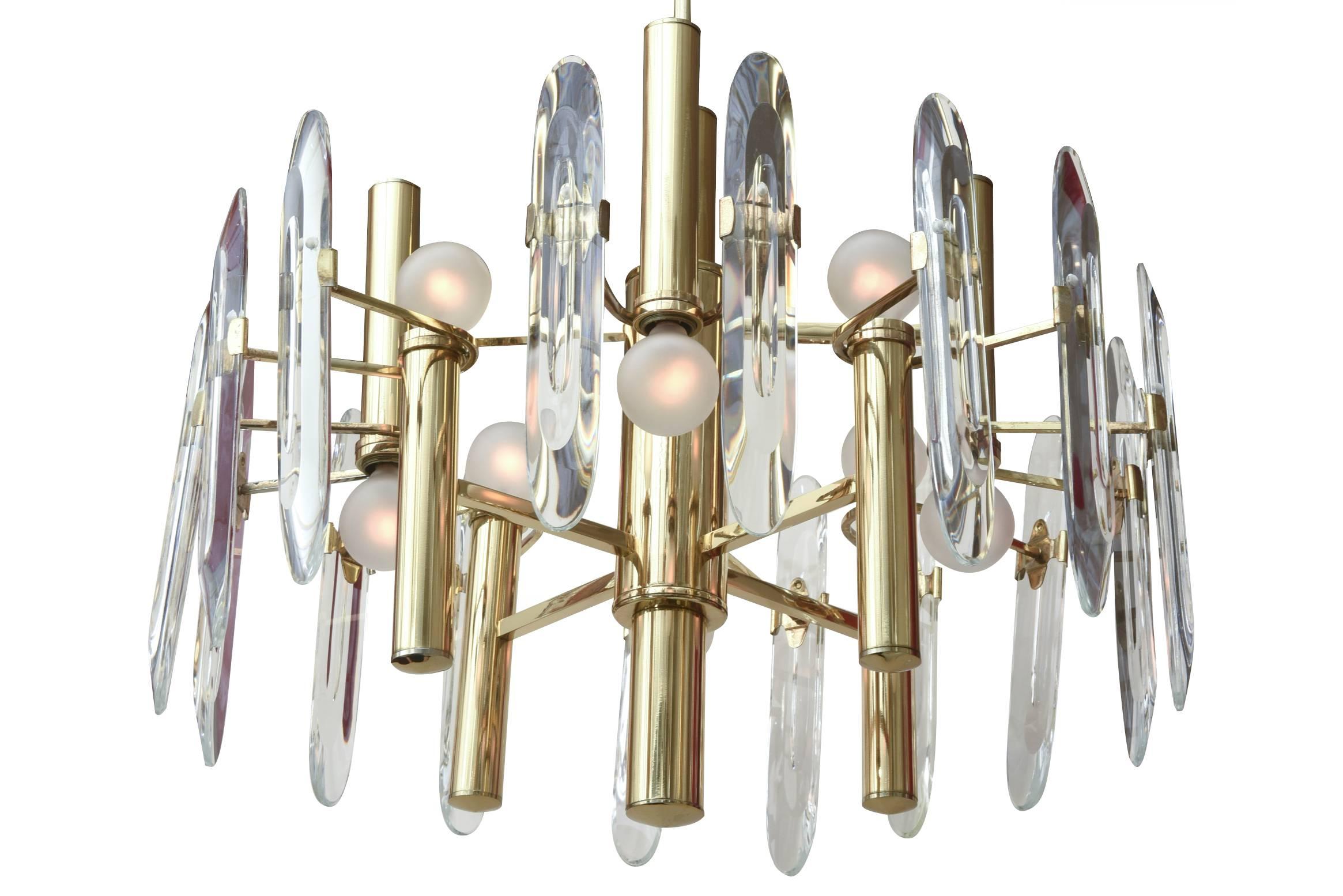 This modern elegant Italian vintage Gaetano Sciolari eight-light chandelier has 16 beveled crystal prism glass pendants that attach to each arm. They do detach for shipping. The light bulb placement alternate up and down. It has been re-plated to a