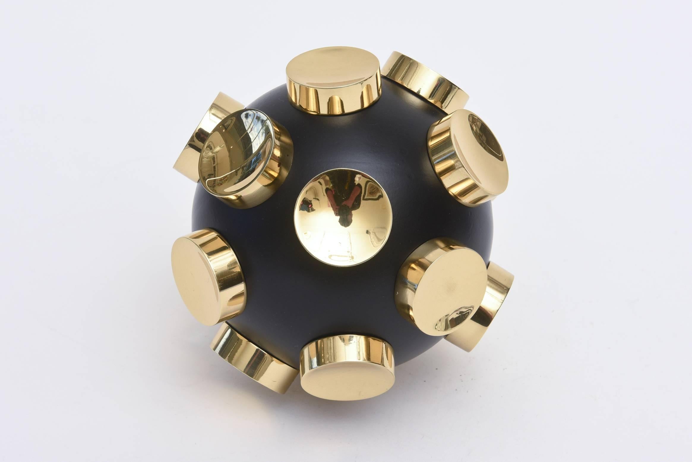 This amazing round sculpture has polished brass protruding caps that come unscrewed. The form is fantastic and has organic modern influences. The black is a combination of resin and painted aluminum. It has great weight to it.
Most unusual and