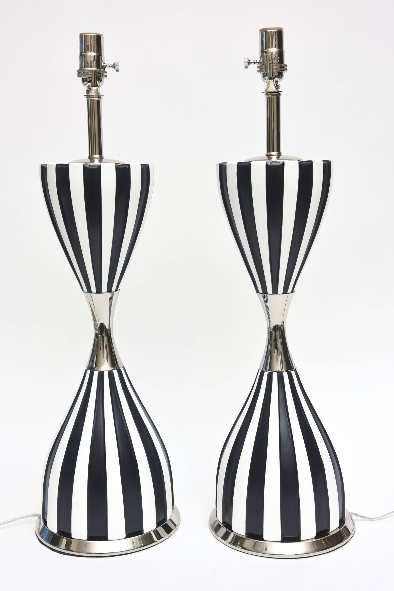 These dramatic and arresting black and white Laurel Mid-Century Modern ceramic lamps with nickel silver appointments and hardware have all been restored. We have now made them look more modern to the 21st century now and many costs have go into the