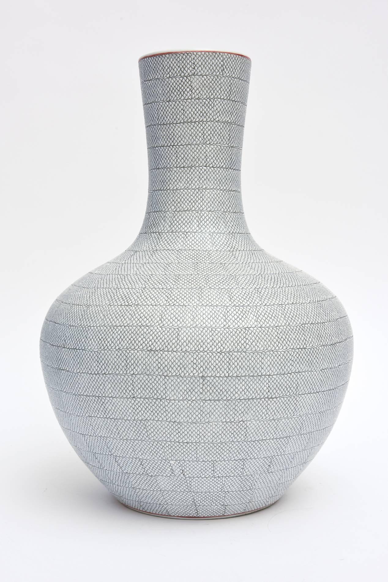 This amazing and beautifully executed hallmarked porcelain vessel or vase is Mid-Century. It has a textural snakeskin effect in grey over white. The top has one Fine line of orange. This stands alone as a great piece of Japanese porcelain.
It is