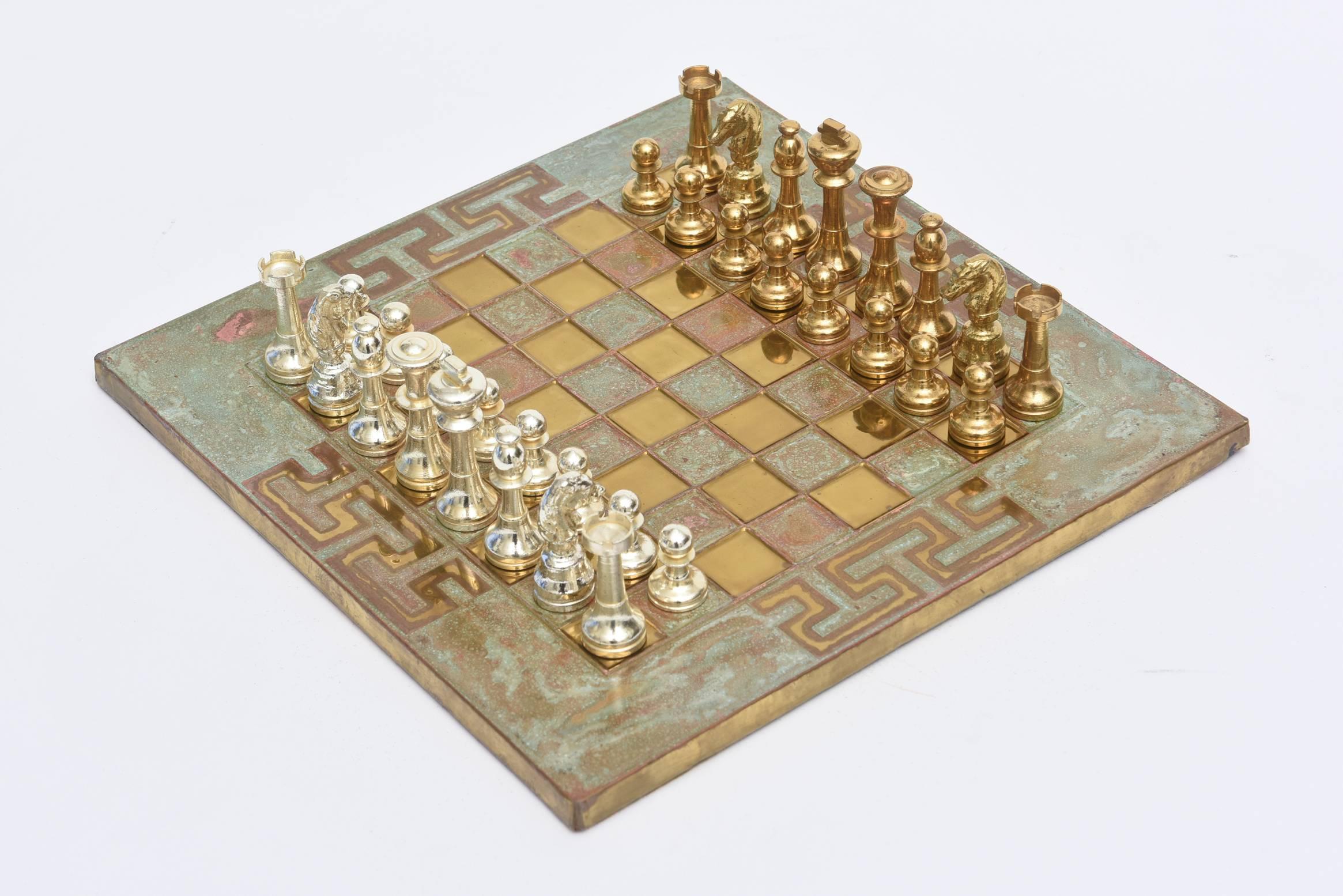 These signed small vintage Greek chess set has the modernist yet Classic Greek key pattern. Signed Forma Greece. It is Mid-Century Modern.
The players are a combination of chrome and brass. The board is a patinated brass and copper over wood with a