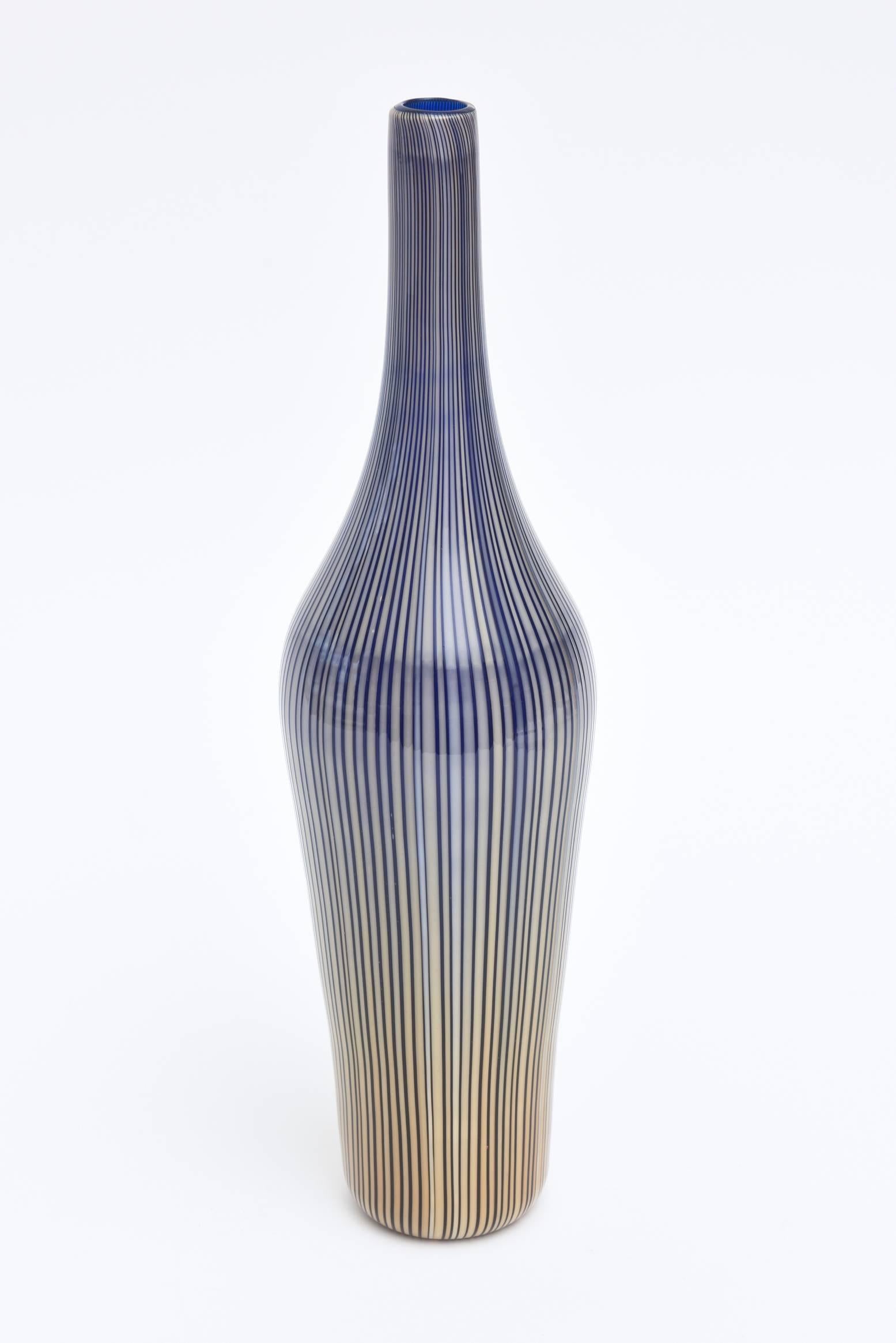 This beautiful Italian Murano stately Cenedese striped cased bottle, vessel or glass sculpture are graduated colors of blue to amber yellows is triple cased glass. It is a decorative piece of sculptural glass or vessel in bottle form. The original