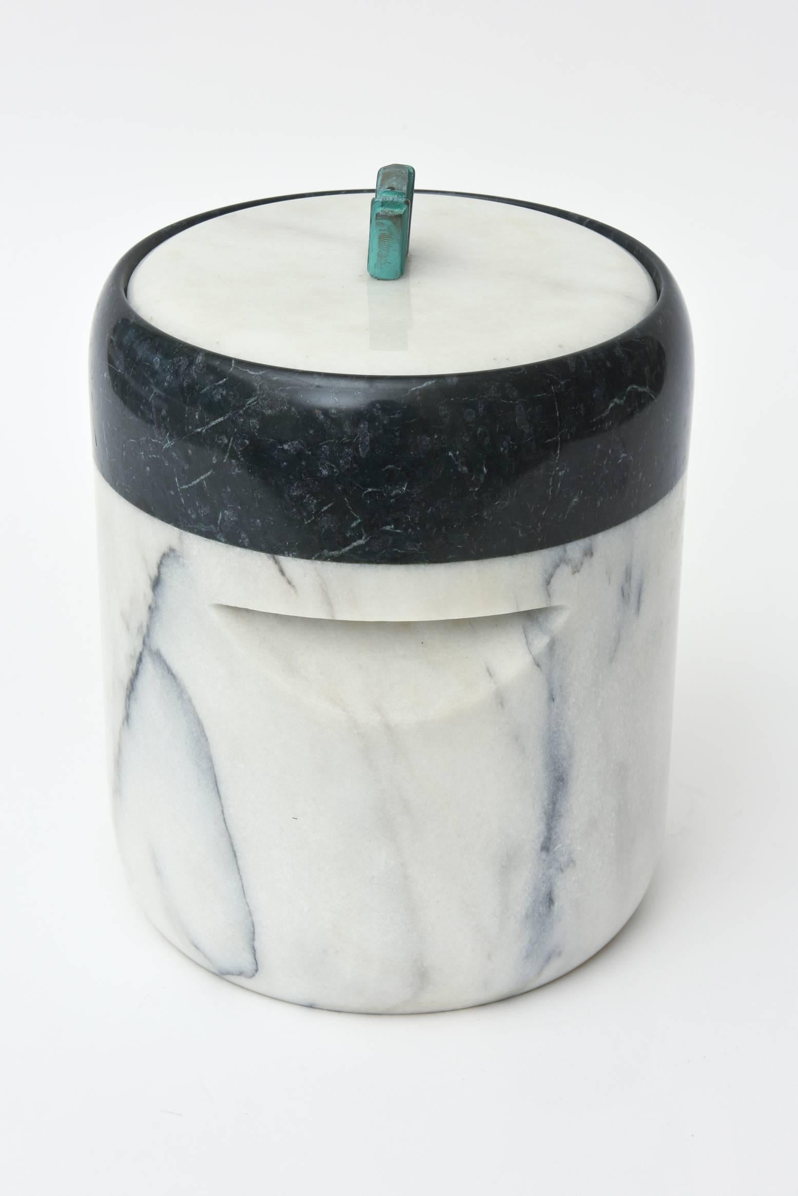 This vintage Mid-Century fabulous sculptural two part ice bucket is variegated marble with a patinaed bronze sculptural fluted handle. There is a indented sculptural form in the centre of the ice bucket.
It is signed Georges Briard Inc. Tawian and