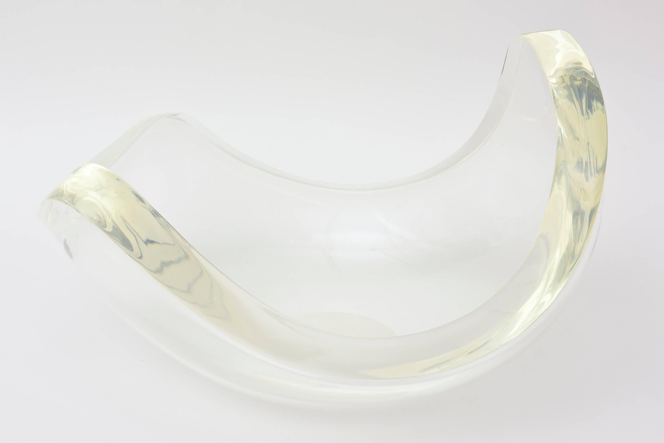 This most monumental organic/sculptural biomorphic shaped thick Lucite bowl
is stunning. It is vintage and has three different height of the biomorphic points. The highest point is 10.5" H then 9.5" H then 7" H. From every angle, it
