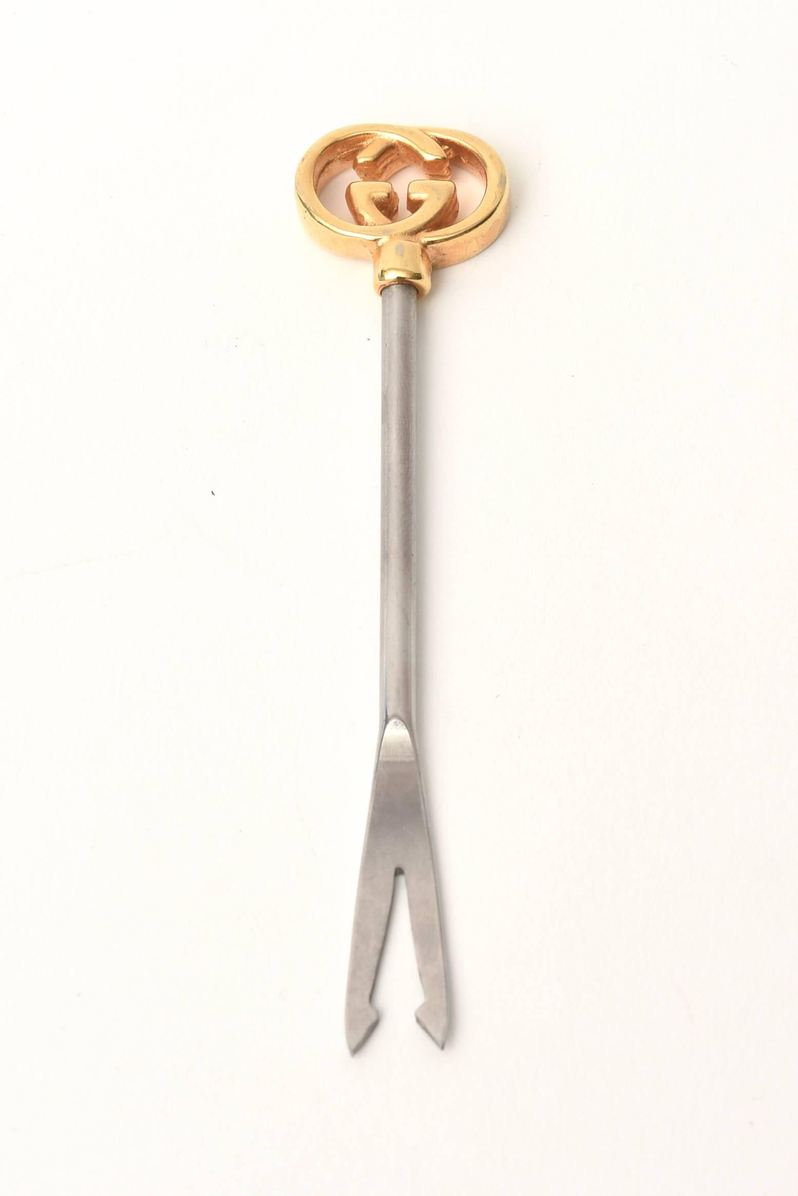 This gold-plated and stainless steel Italian Gucci olive pick is fabulous for all your entertaining. It is signed Gucci Italy-stainless Germany.
Great barware.

   