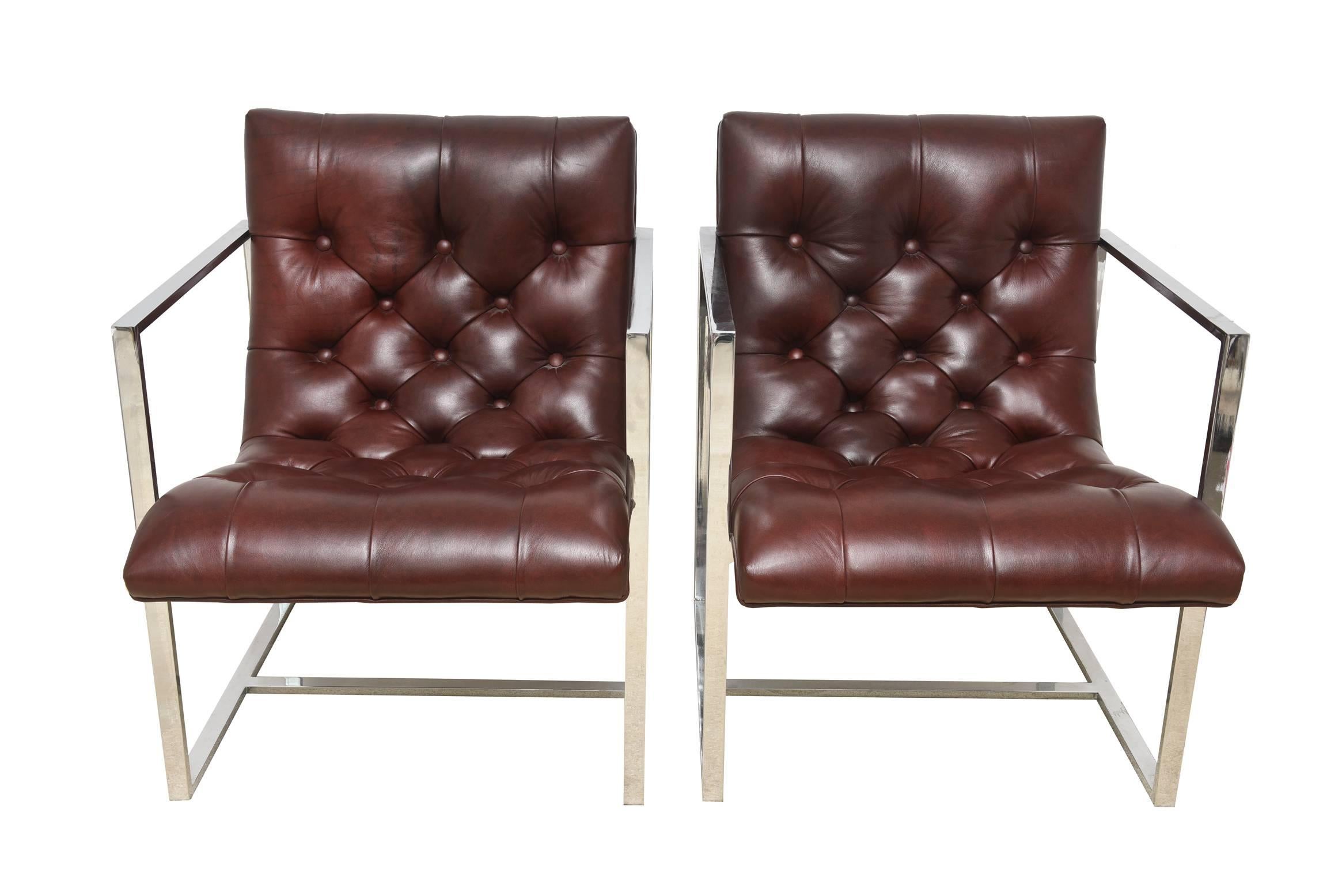These gorgeous pair of vintage Milo Baughman attributed architectural side chairs or lounge chairs are a chrome frame with fine leather tufted seats in a brownish burgundy color. They have buttons of leather as part of the tufting. Their form is of