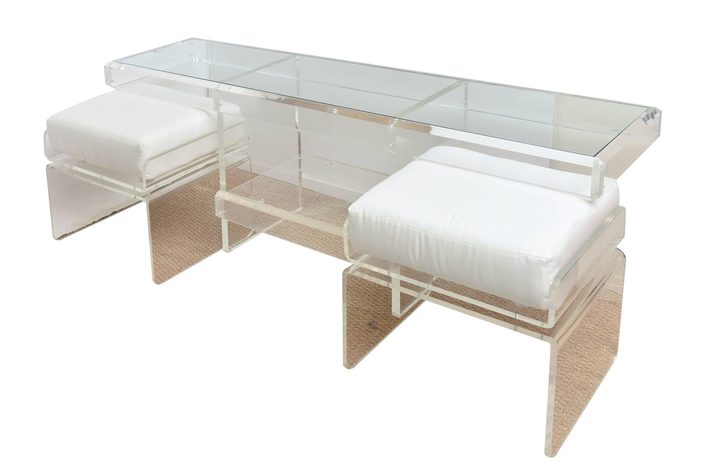 This most diverse and utilitarian Italian vintage lucite low console has two pull-out lucite and upholstered benches. It has a glass top and glass bottom. 
Great for a large contemporary painting hanging over it or a flat screen TV.
A great pair of