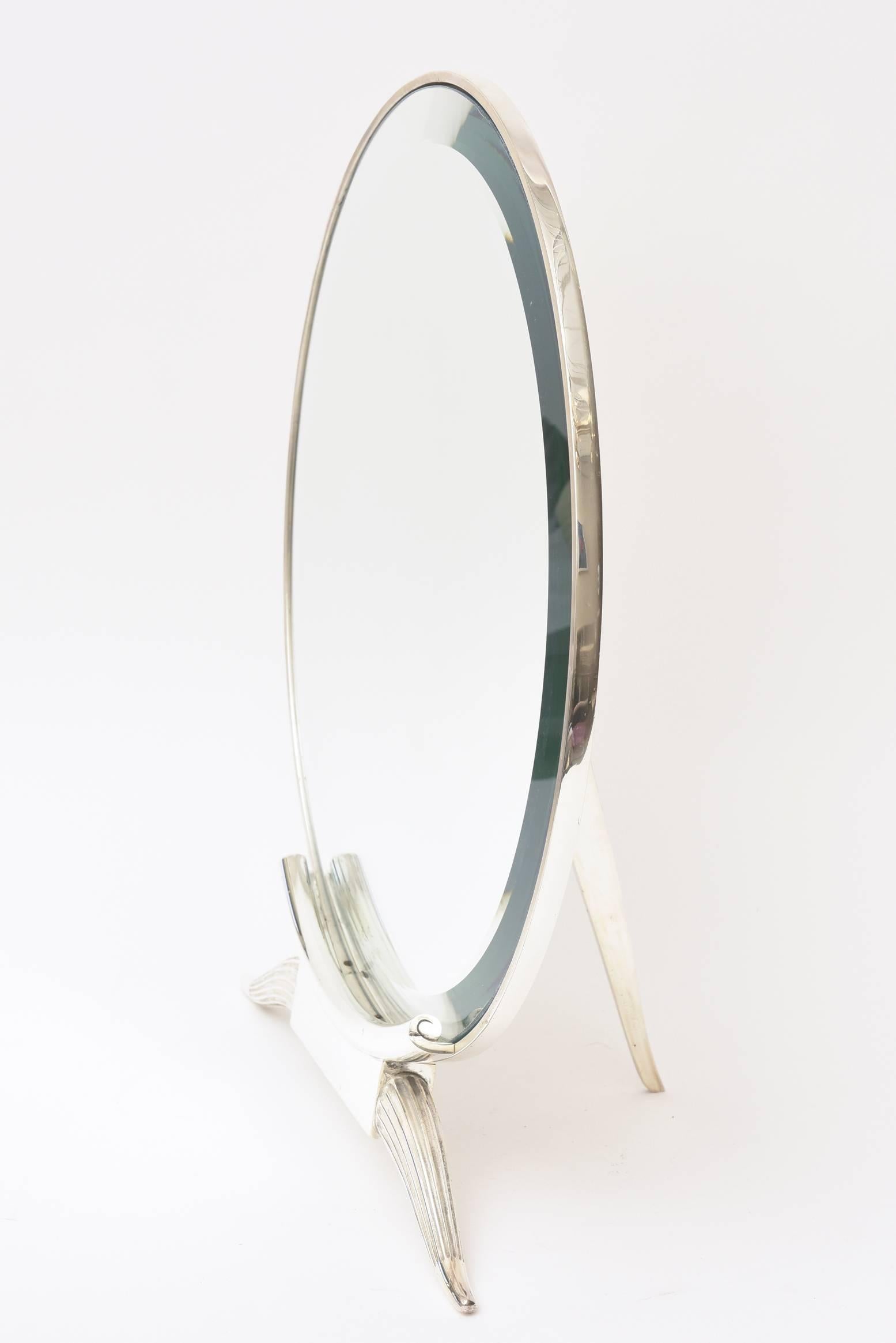 This exquisite and substantial period vintage Art Deco signed Émile Ruhlmann tabletop or vanity mirror is silver plate over bronze. It is called the antelope mirror. A new beveled mirror of 1 inch bevel has been replaced with the broken one. It has