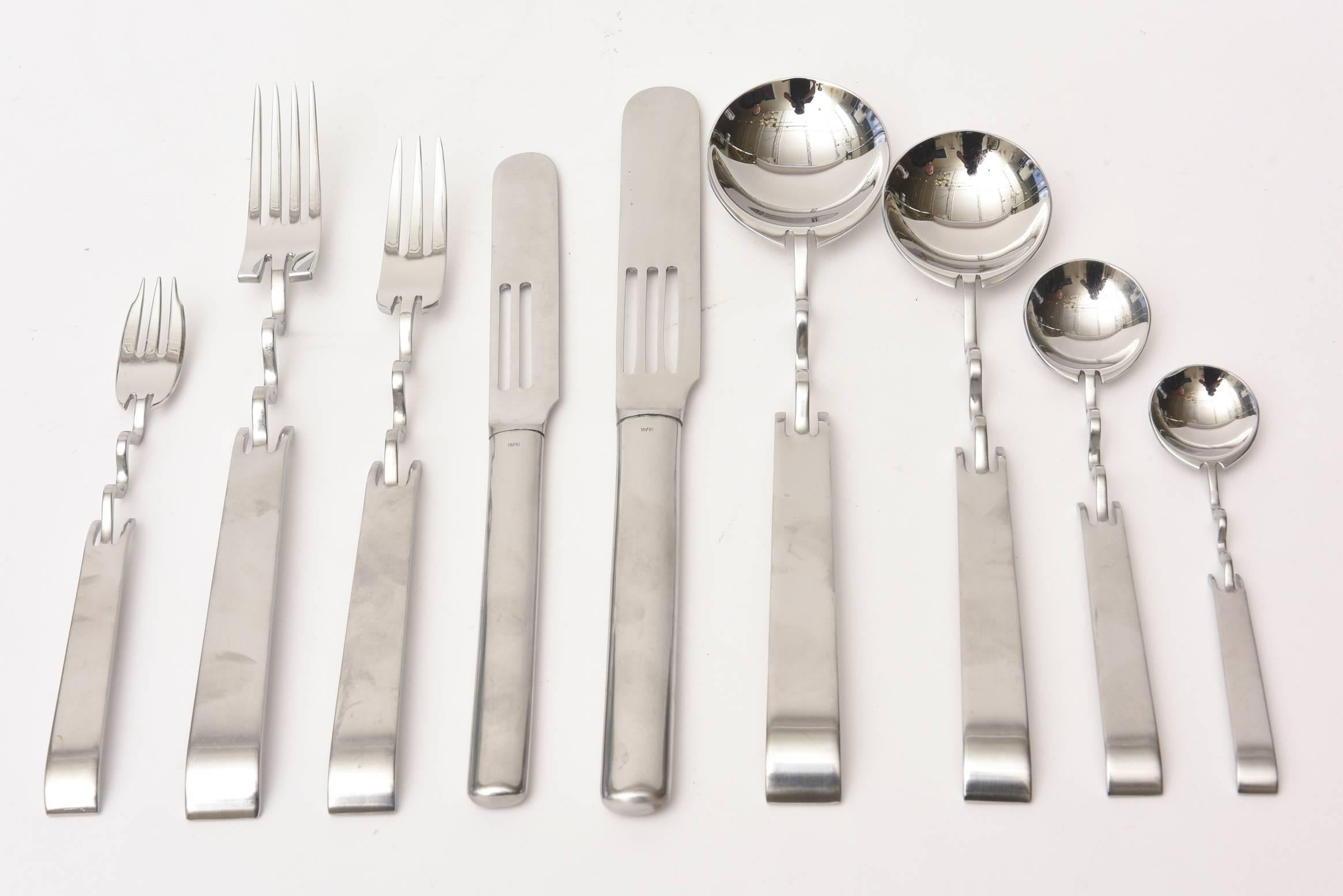 This sculptural and extremely rare set of 60 pieces of stainless steel signed Sabattini for Rosenthal flatware is so amazing. It is signed Rosenthal and designed by Sabattini. It is a work of art and sculpture as flatware for your table. It is