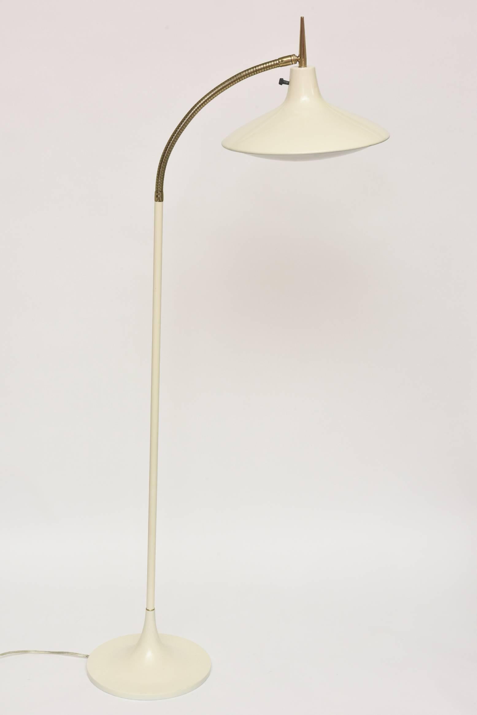 Painted metal and brass make up this Italian Gio Ponti style flexible arched floor lamp.
It has been restored with new paint over the metal and the brass has been polished and it has been all re-wired. It is the same cream color that was originally