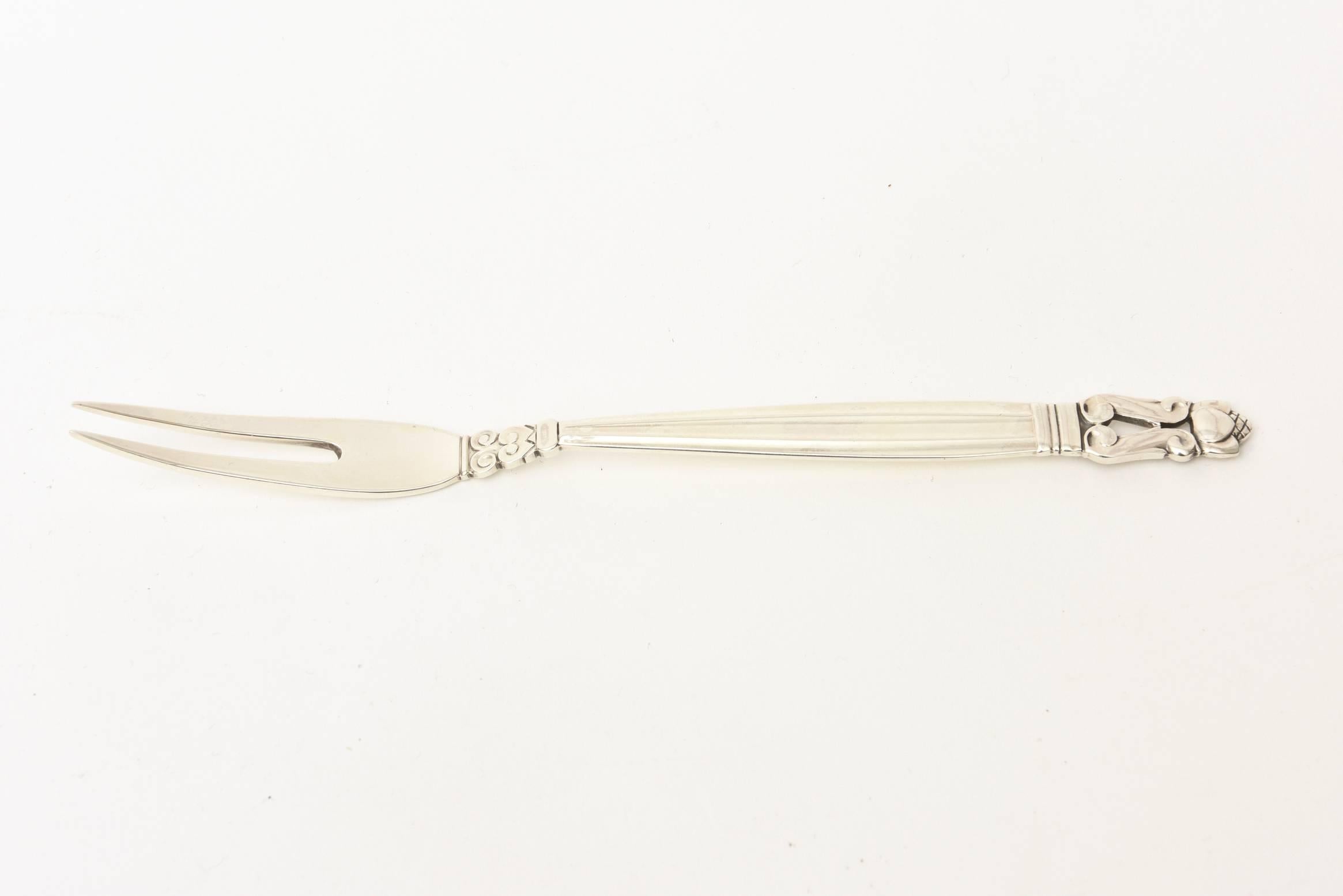This classic and vintage hallmarked Danish signed Georg Jensen sterling silver pickle fork is perfect for all your entertaining. It is of the acorn pattern.
It is a forever piece for your dining or barware.

 