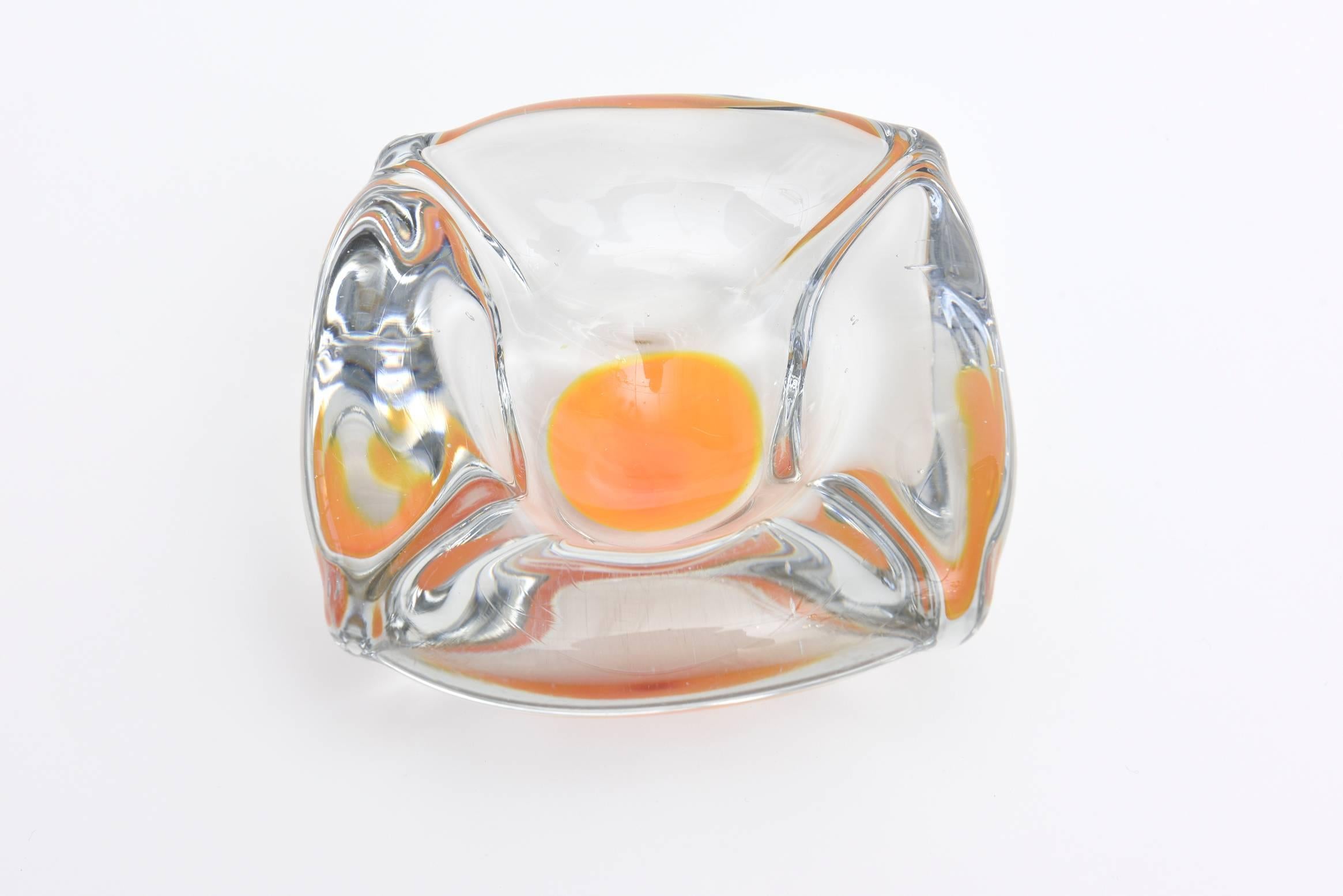 This lovely clear and yellow centered Swedish glass bowl is perfect for serving. This company was founded in Sweden in 1888.
it almost looks like an egg yolk with a red dot and is called Coquille.
It is heavy and vintage from the 1960s. It was