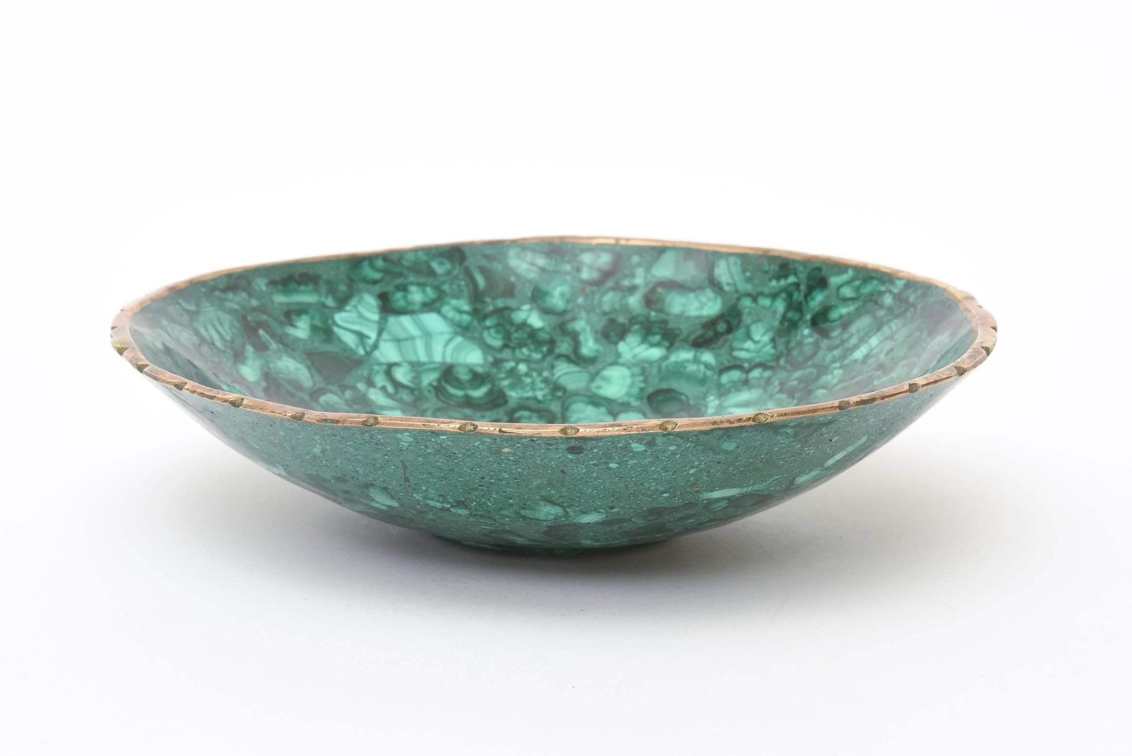 This Russian malachite and bronze vintage midcentury bowl is so gorgeous. The malachite stone design is one of the prettiest we have seen. It is midcentury. It sits not perfectly even as it is a natural stone.
The semi scalloped rim is