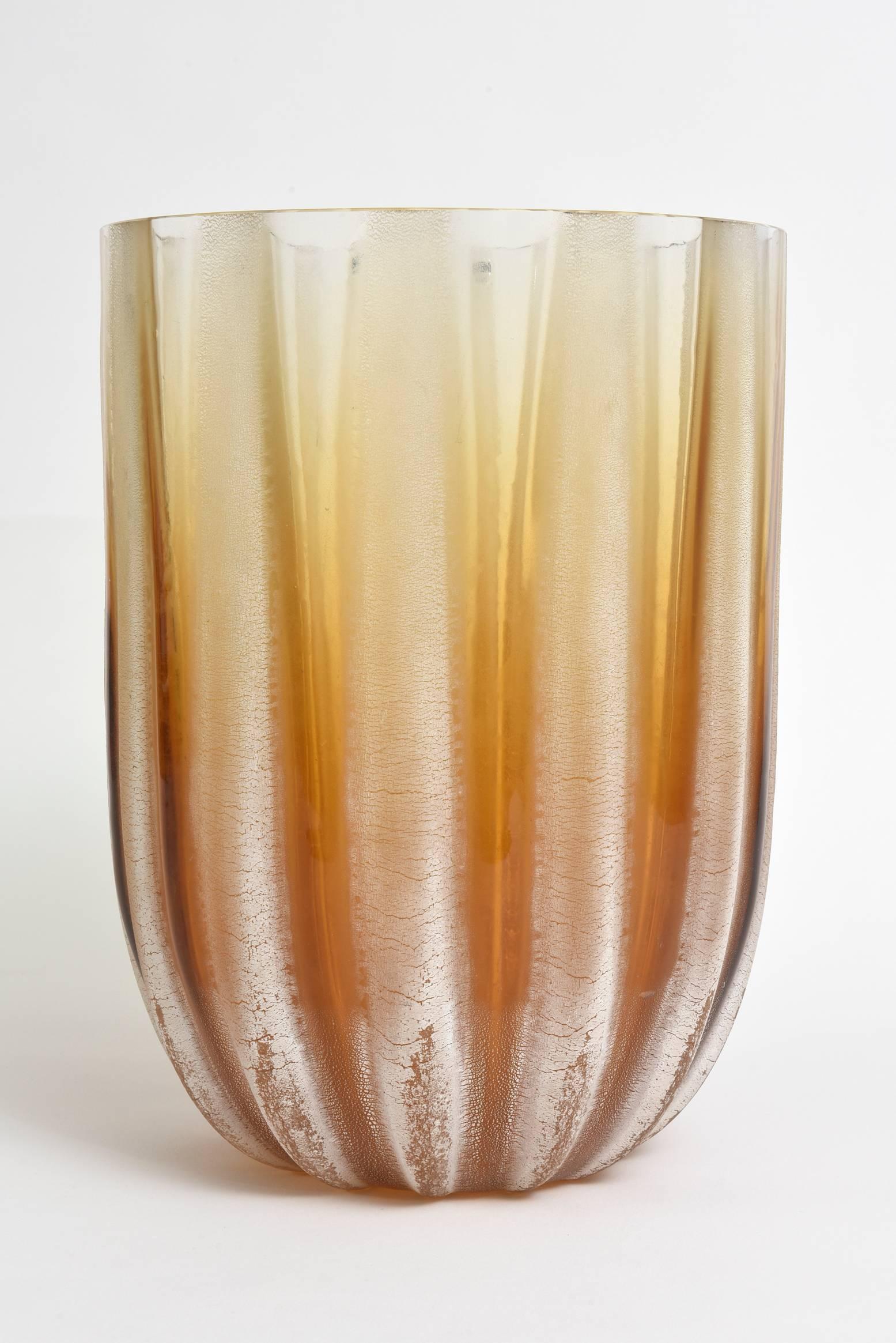 This stunning and monumental textural Italian Murano Barbini acid etched glass vase is a real beauty. The alternating stripes of amber and off-white in acid etched technique offer dimension and texture.
The original Barbini plastic label is on
