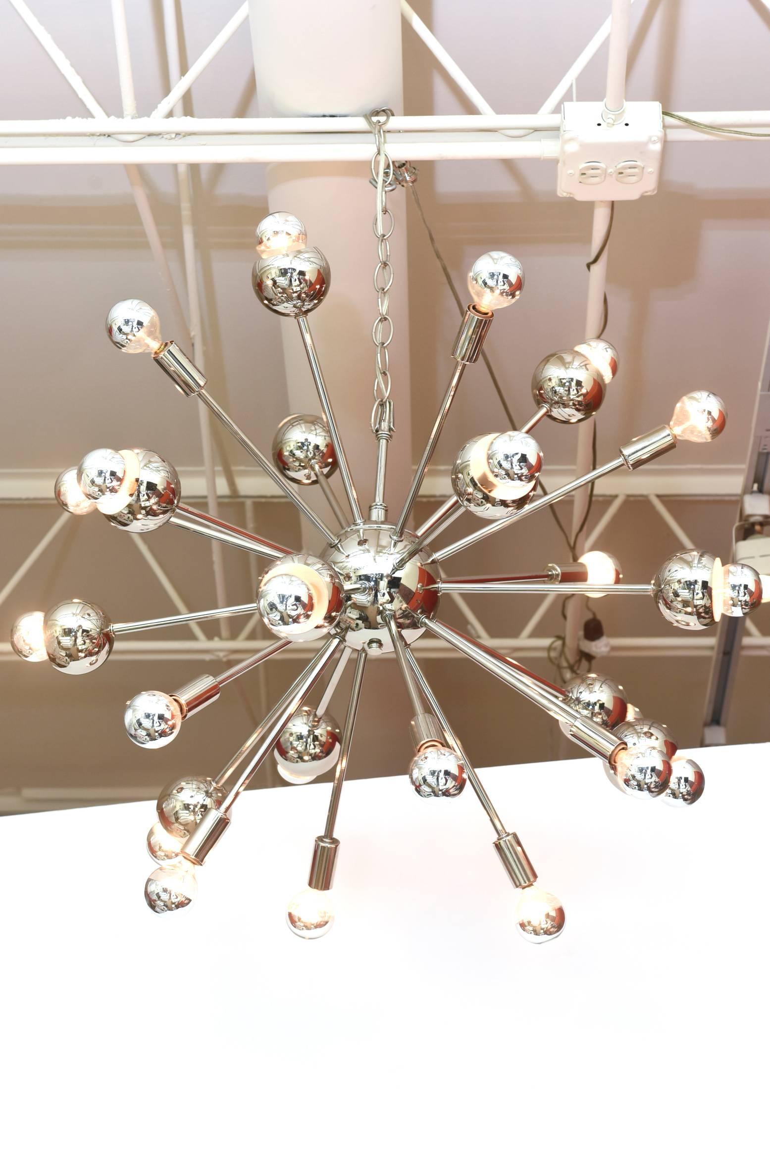This many arm of 24 bulb sputnik chandelier has been re-nickled silver and rewired. There are of different lengths of the bulbs making it more sculptural It has gone through a complete restoration. It is vintage and from the 60's. The special bulbs