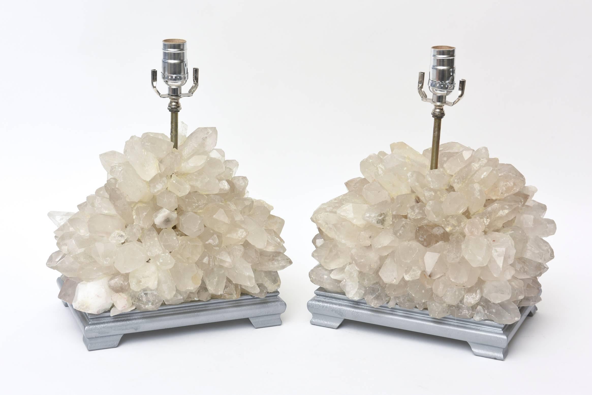 These pair of low vintage Carole Stupell quartz rock crystal lamps table/console lamps are quite stunning.
The original bases were previously silver leafed with a lacquer finish. We have not changed them from their original state as obtained nor