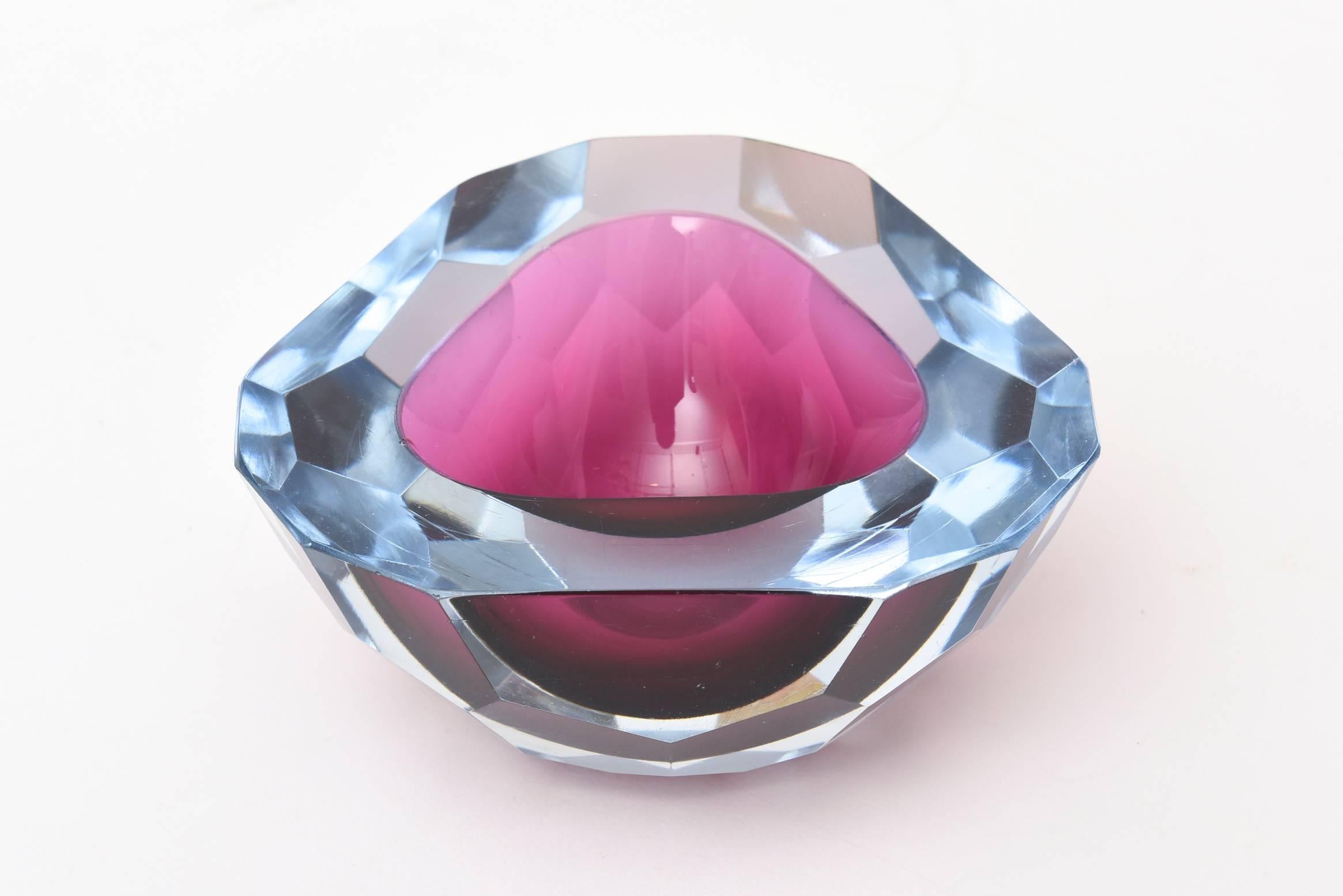 This stunning combination of brilliant and luscious colors of magenta raspberry pink and blue make up this Italian murano geode bowl with a flat cut polished top. it has chiseled diamond faceted sides that look like a honeycomb pattern. It has been