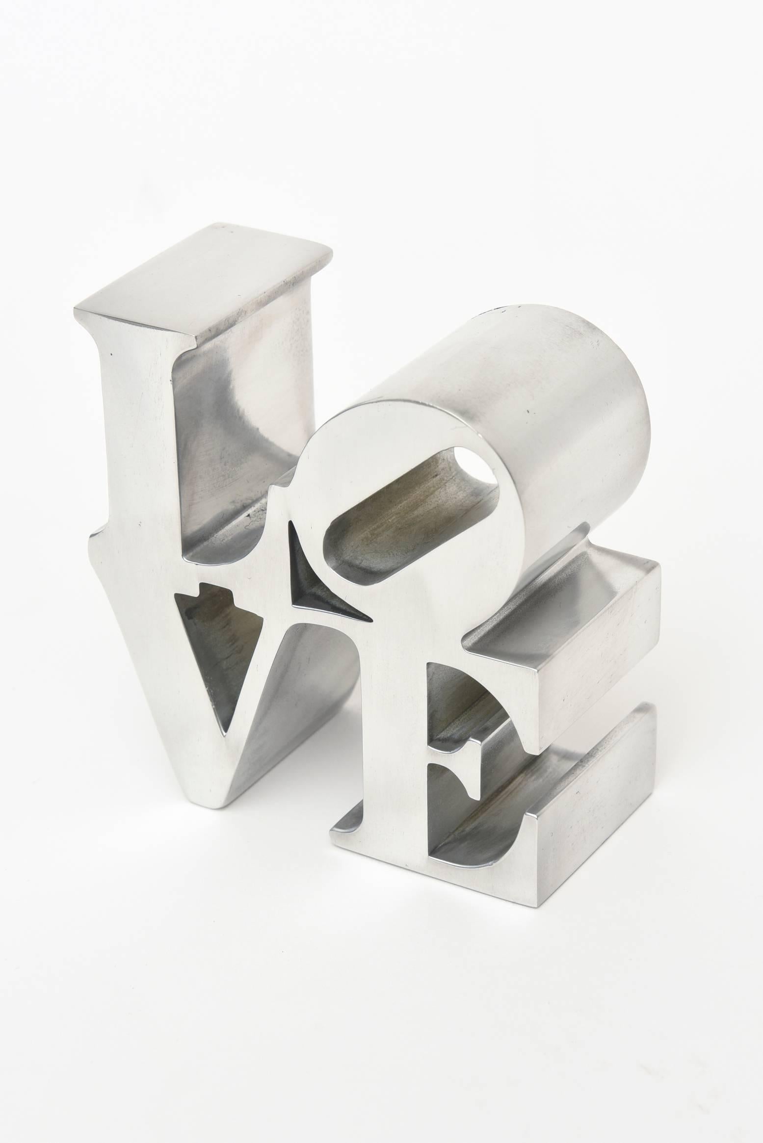 This polished aluminium love paperweight/ desk sculpture by Robert Indiana is from the 1970s.
Robert Indiana became famous for his love sculptures and paintings.
It was originally sold in museum stores such as MOMA at that time.
At this time in