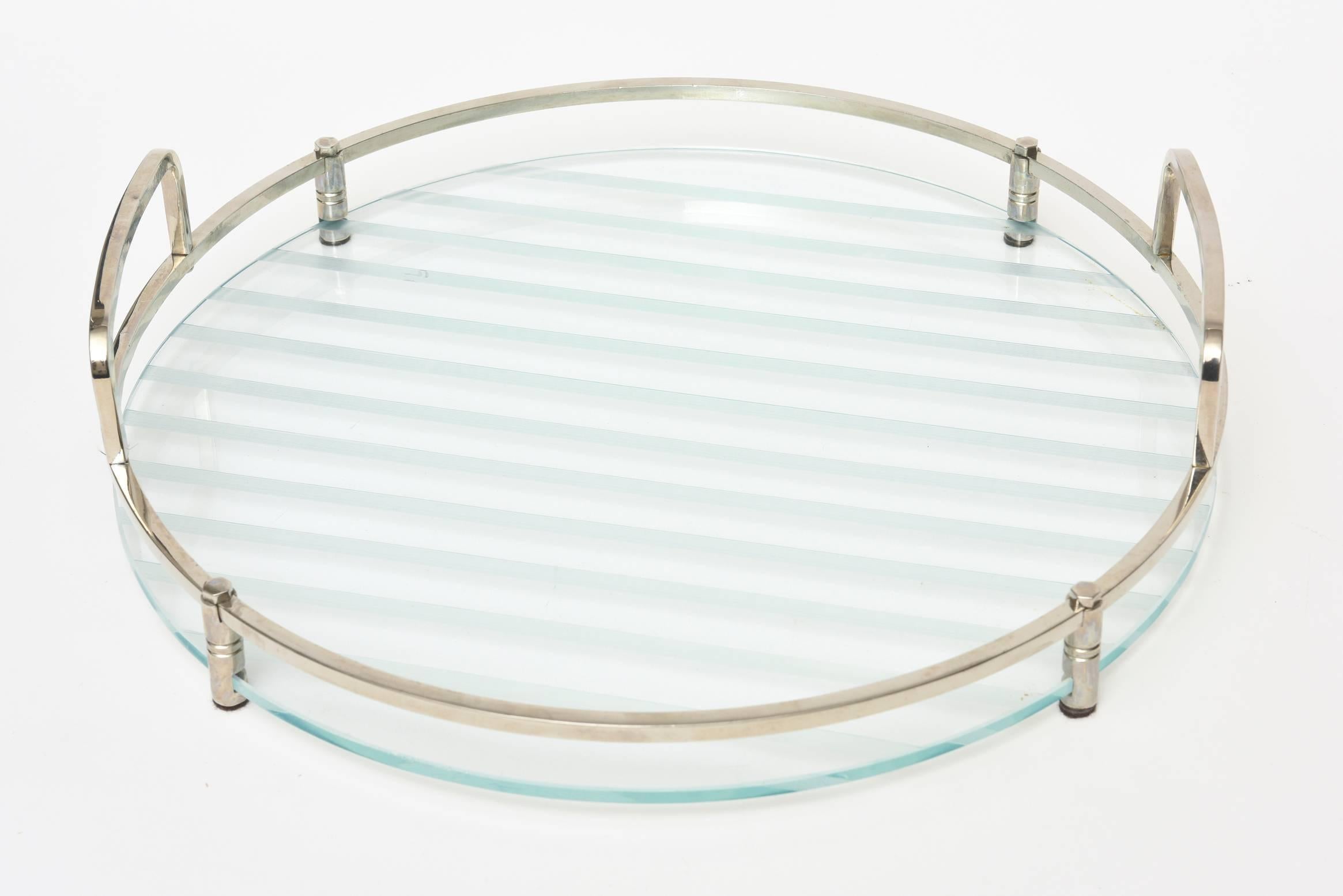 This round versatile etched glass tray with white lines is great barware and or a serving tray. The chrome adds to the modernity of it even though it is from the 1970s. The height below is the height to the top of the handles.
This could be used