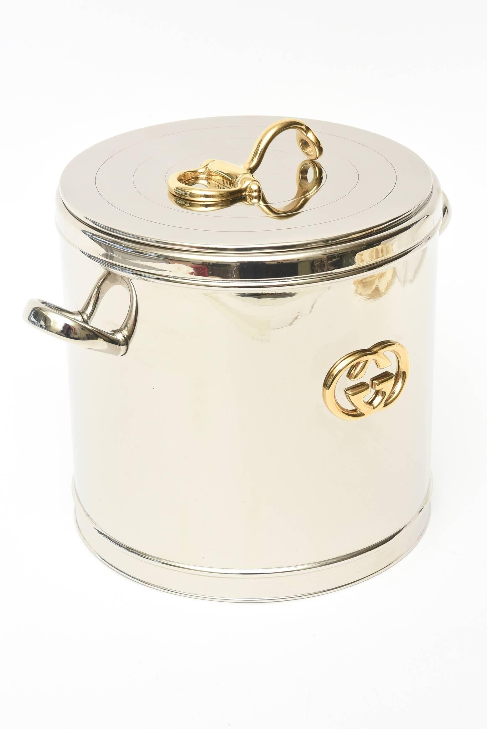 This gorgeous Italian vintage hallmarked Gucci horse bit ice bucket has been completely restored. It has been replpated with the original 22-karat gold plating on the designated areas and GG's. The other part has been re silver plated.
It has a