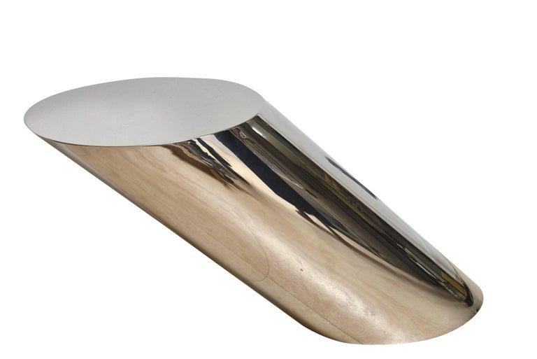 This iconic sculptural and angled vintage stainless steel side or end table was designed by J. Wade Beam for Brueton. It is called the Zephyr table. This is like art and sculpture in a side table. It has been recently completely polished