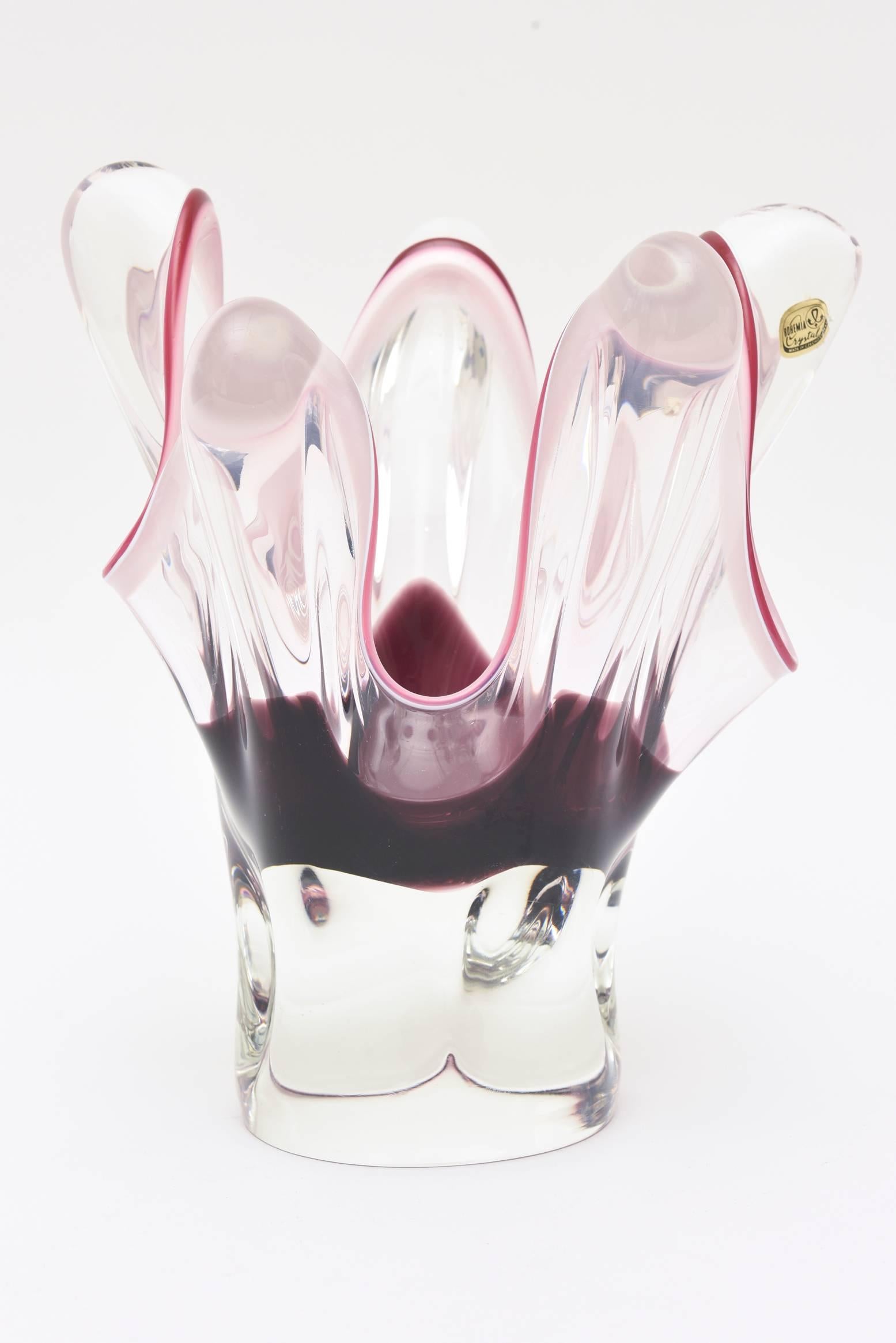 This Czech Bohemia sculptural glass vessel and or vase with its original paper sticker has a very sexy shape with protruding vertical tentacles. The colors are stunning in Sommerso form. The outline is a darker and lighter pink with clear on the