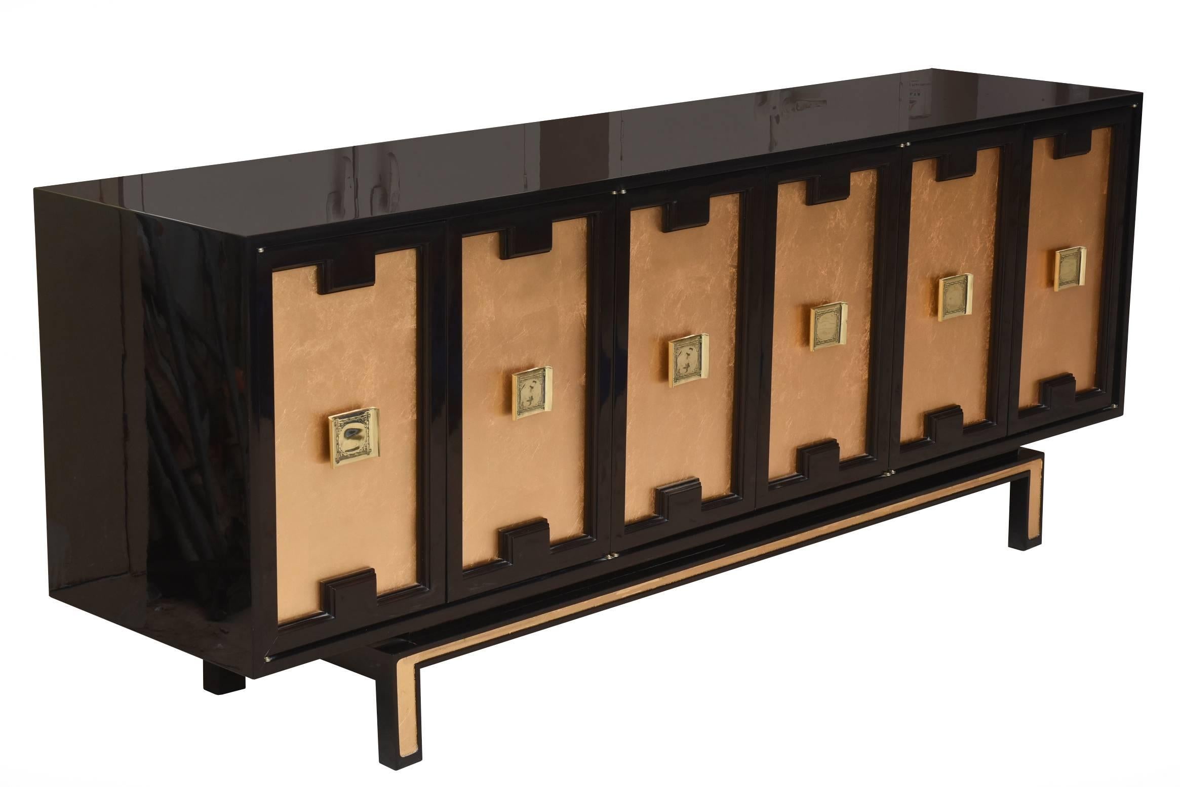 This restored lacquered wood with gold leaf and brass hardware cabinet, credenza or buffet vintage cabinet is dramatic. It is stunning and newly restored vintage 1960s cabinet or buffet that has been brought to the 21st century. It is regal and rich