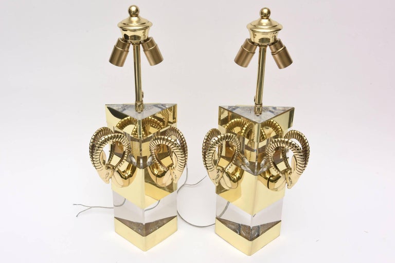 These dramatic vintage lucite and brass wall sconces have the ram’s heads on either side. They have a very Hollywood Regency style to them. They have been restored and polished to the best they can be. They have also been rewired. There are no