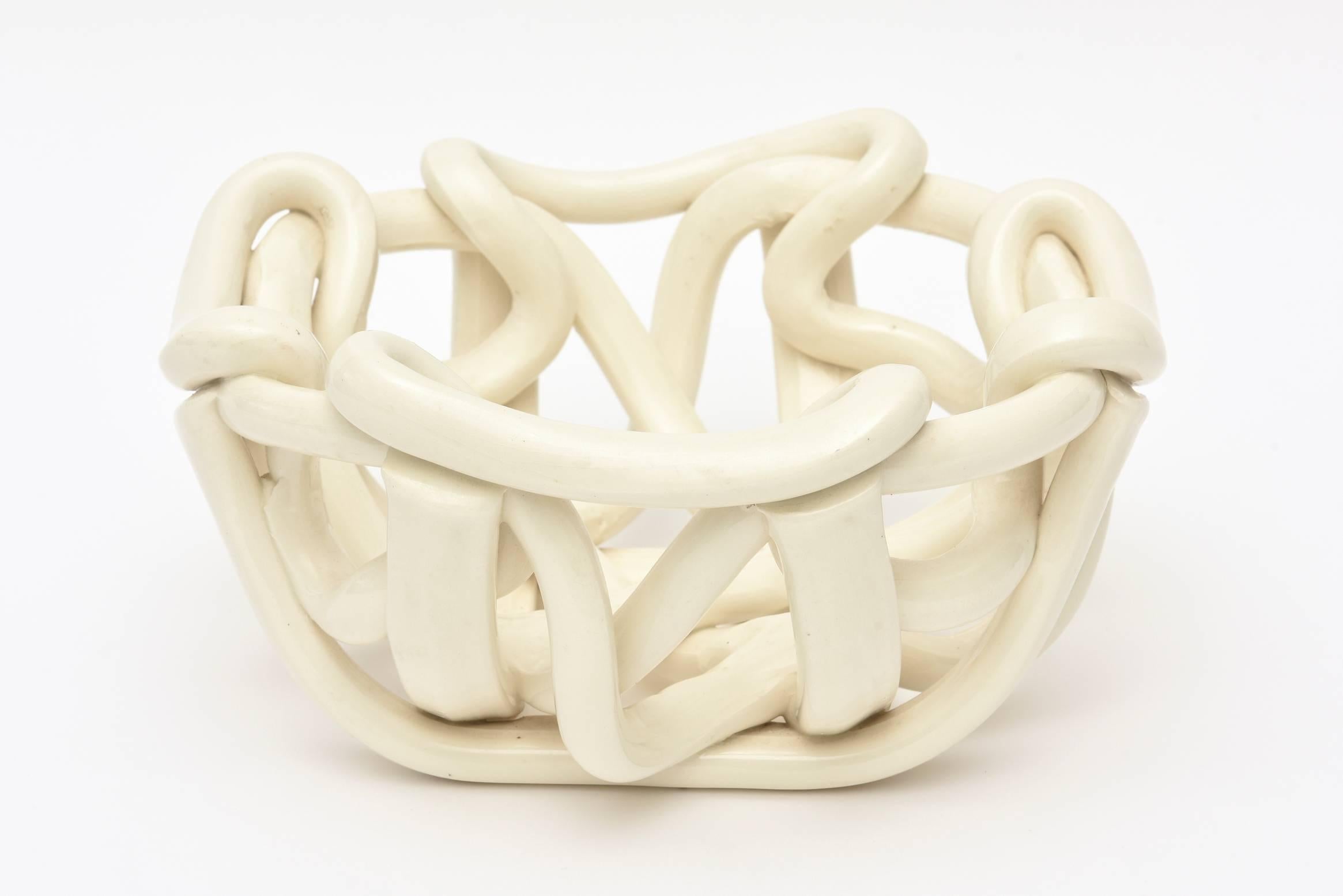 This wonderful vintage twisted and sculptural Italian ceramic bowl is off white to cream. Each angle and way you look at it changes a bit of twisted form. Organic modern.
It is sculpture and ceramic form and a bowl; utilitarian and