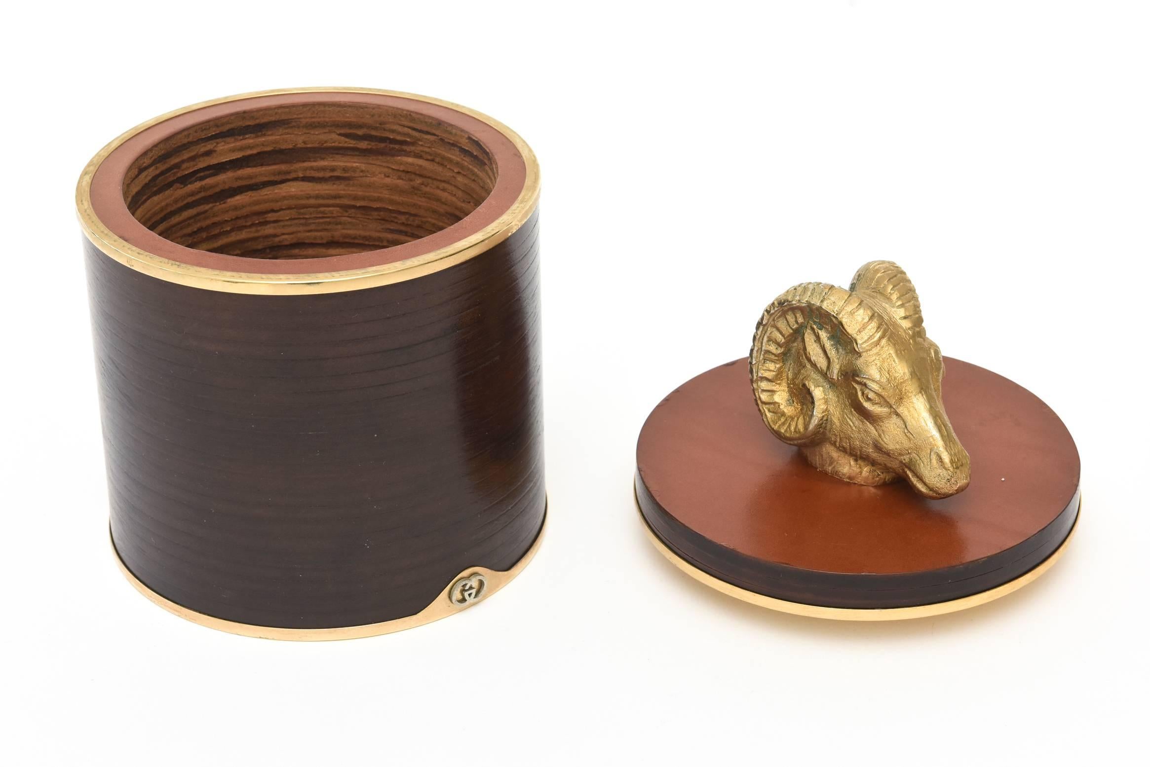 This fabulous Italian hallmarked vintage Gucci two part round ram's head box and or humidor is a great combination of leather, wood, cork and brass. It would be a great desk accessory, library or cocktail table box. It is in restored condition.