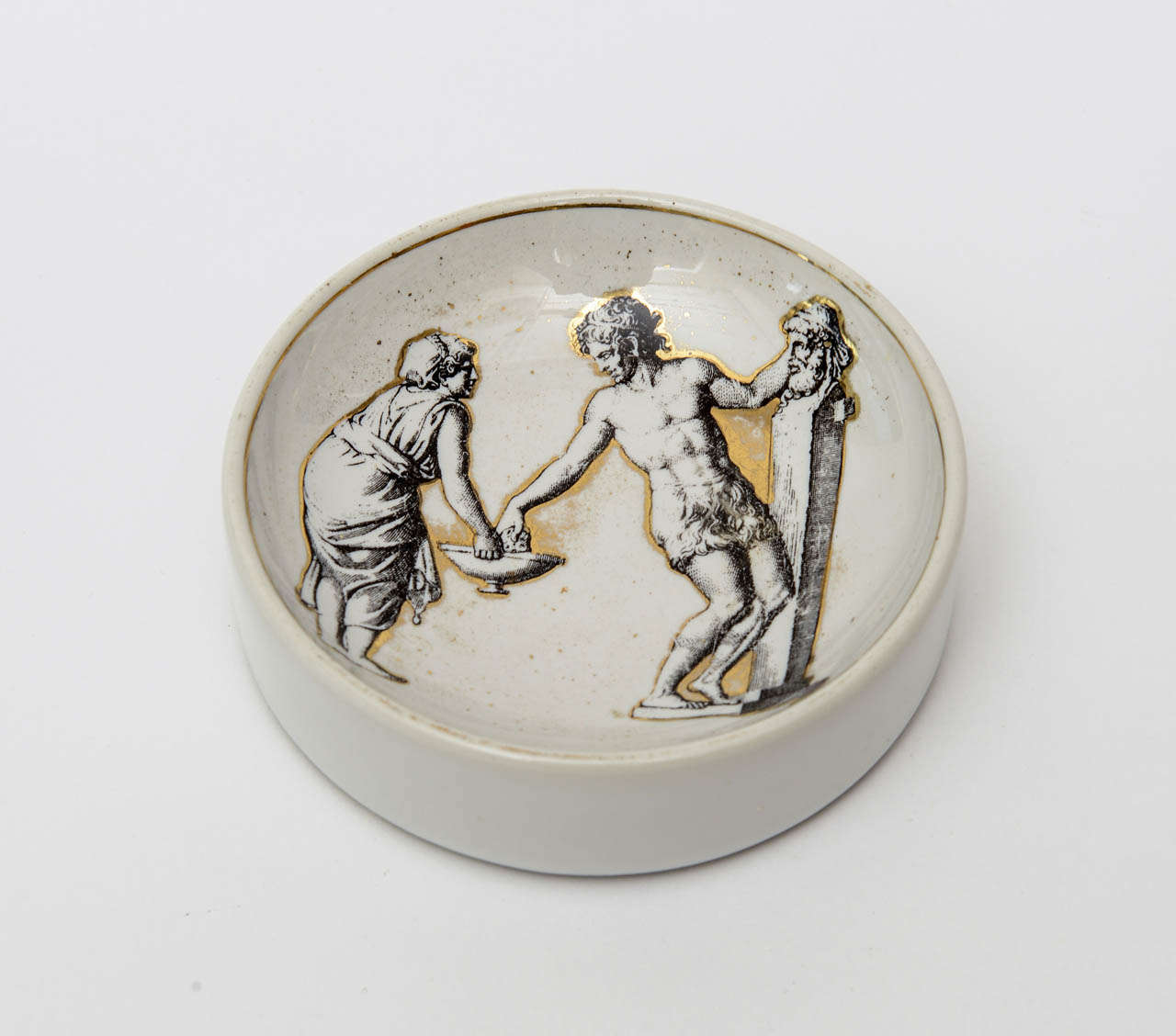 Classical and Roman would elicit the imagery on this signed lovely vintage Italian Piero Fornasetti porcelain gilded bowl or dish. It is hallmarked on the bottom and is Mid-Century Modern.
  