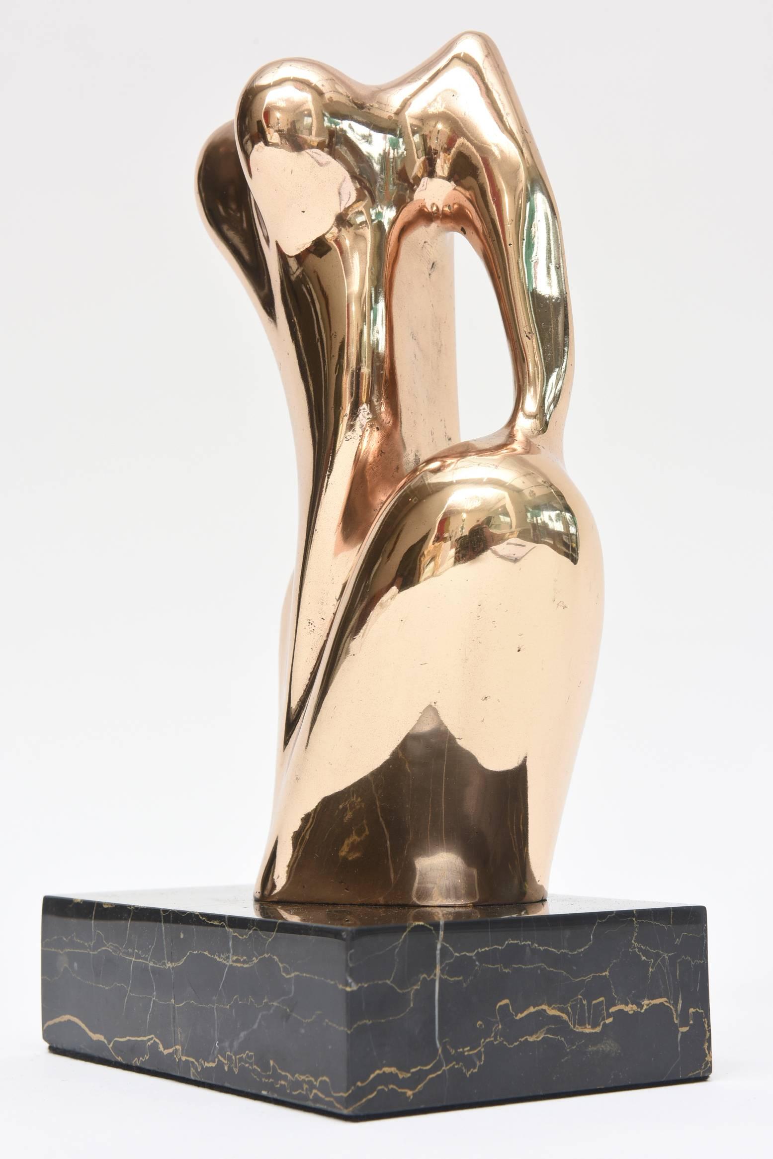 This fantastic female nude bronze abstract sculpture on its original black and gold veined marble base has interesting forms and shapes from all sides. There is a signature on it but unfortunately it is not legible. There is a deep sensuality to it.