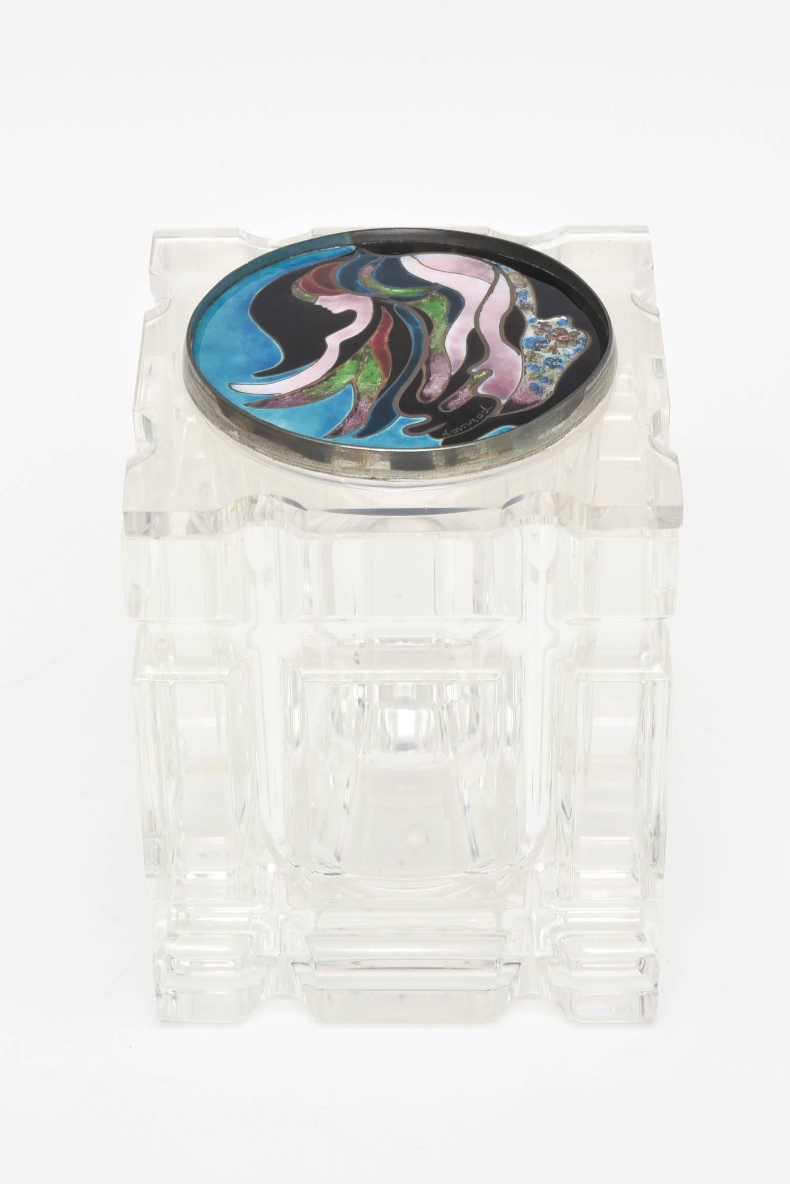 This vintage lucite and mixed-media box, vessel or container has a removable foiled enameled cloisonné top with a spectacular signed artistic design. The colors of the enamel top are turquoise, pink, black, green. white and etc. The abstract top