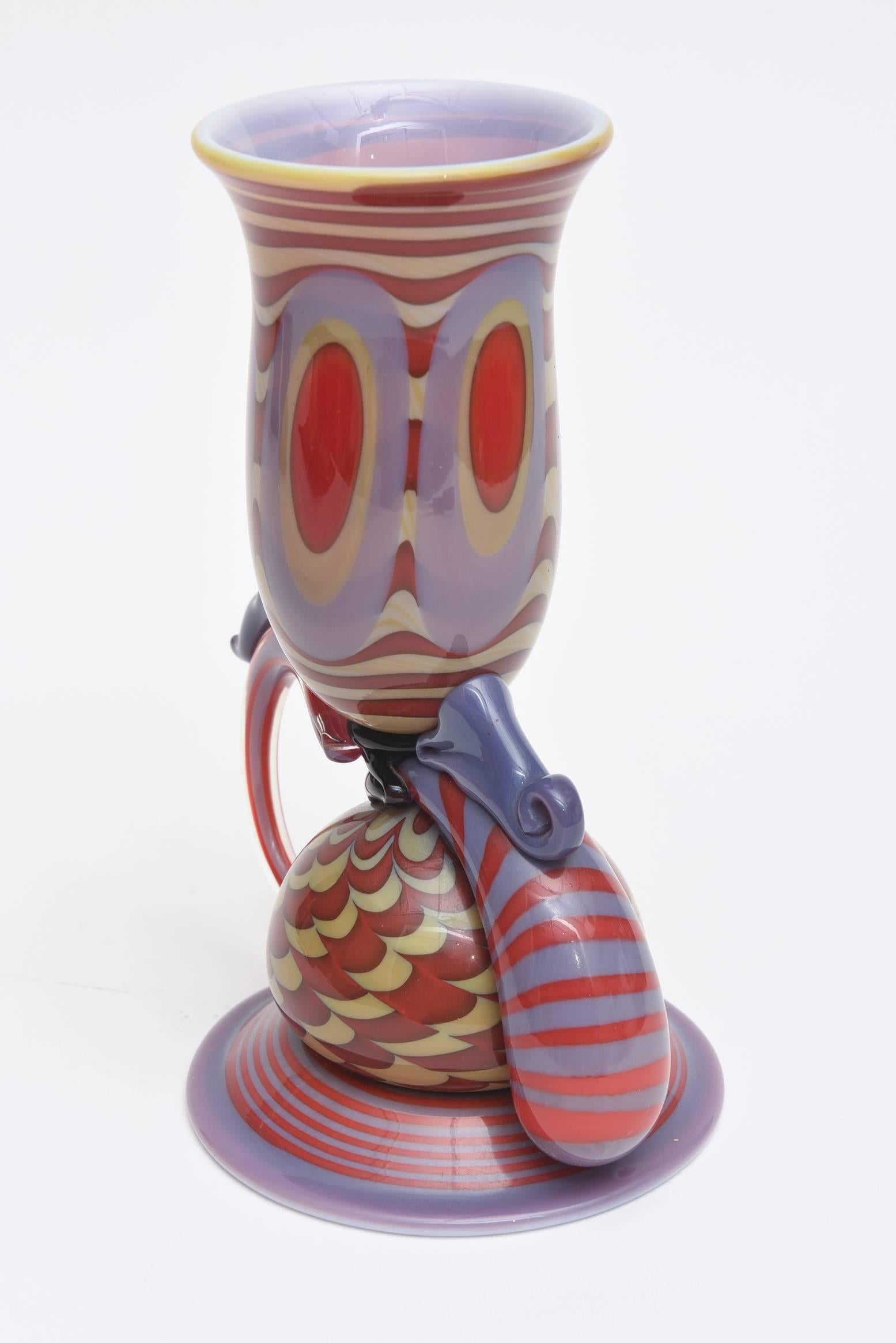  This one of kind American glass sculpture/ vase by Robert Levin is called the banana cup. The colors and form are beautiful. It is from the 80's.
He is a well known glass artist.
This lovely glass sculpture has taken many markdowns now to its final