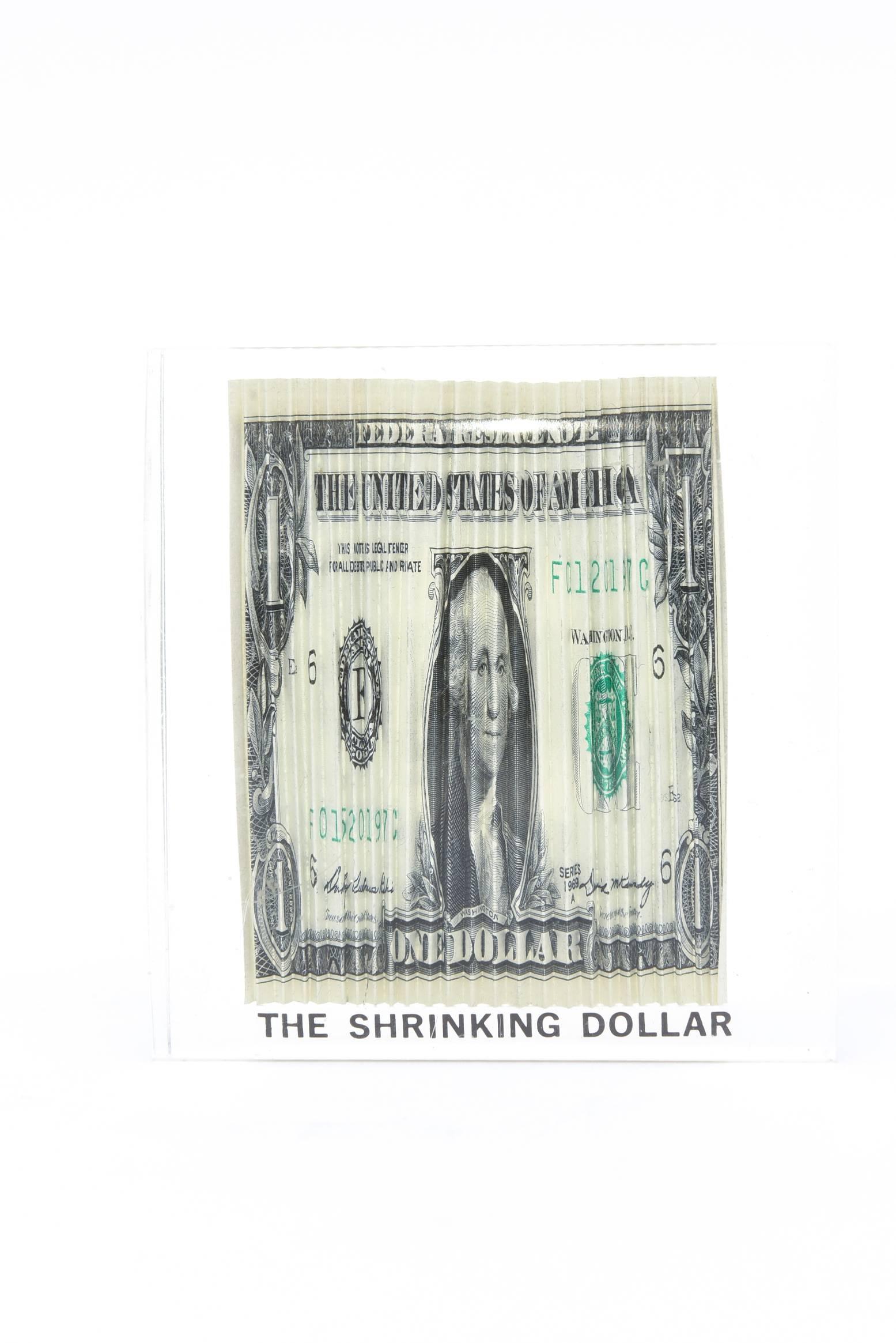 This small pop art Lucite conversational dollar bill sculpture is so current for our times now. It is a accordion pleated real dollar bill shrunk and encased in poured Lucite.
It is entitled: 