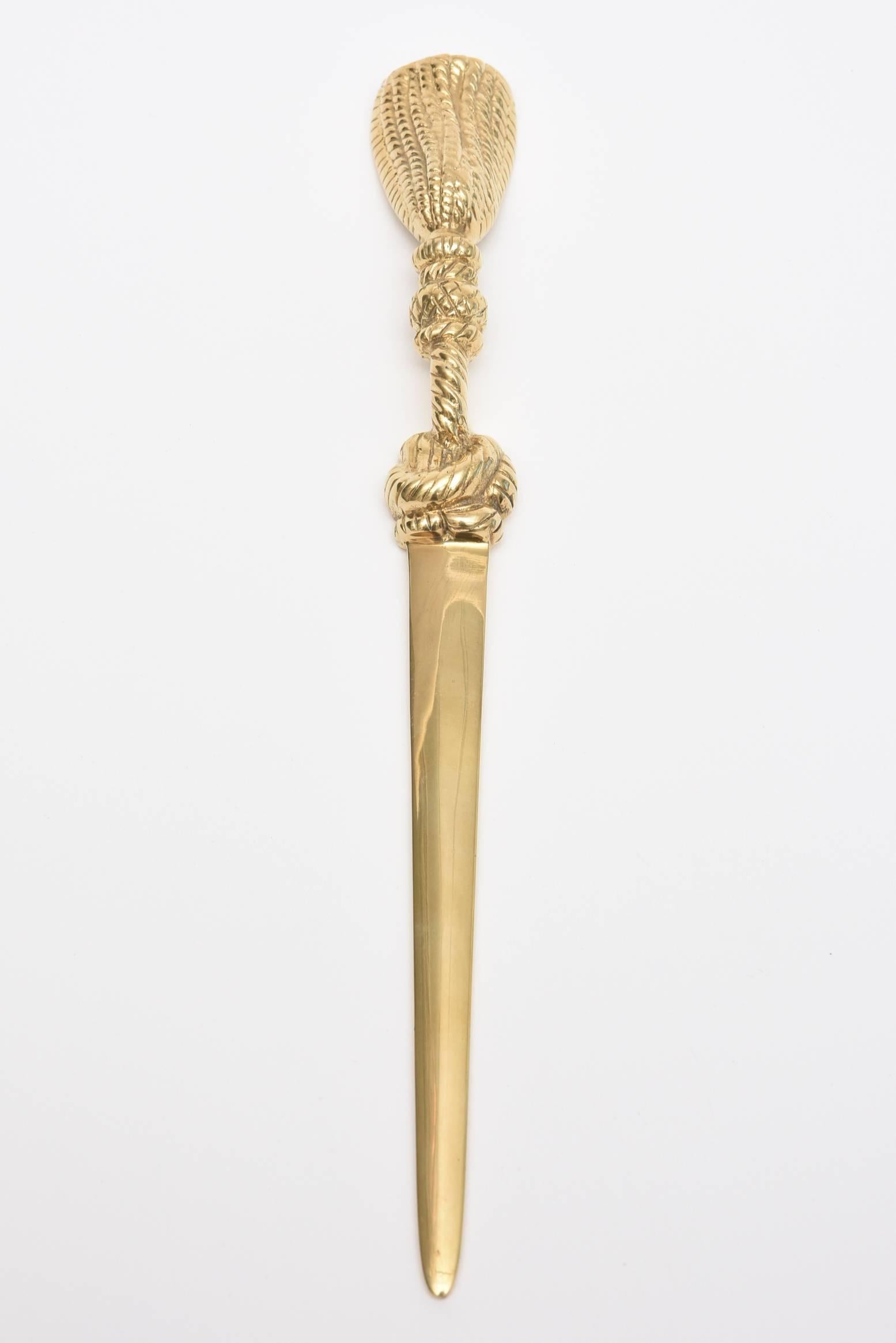 This lovely desk accessory in the way of a solid brass braided and tasseled letter opener is a divine way to open up mail and accept checks. It is from the period of Mid-Century Modern and has good weight to it. This makes a great gift! It is