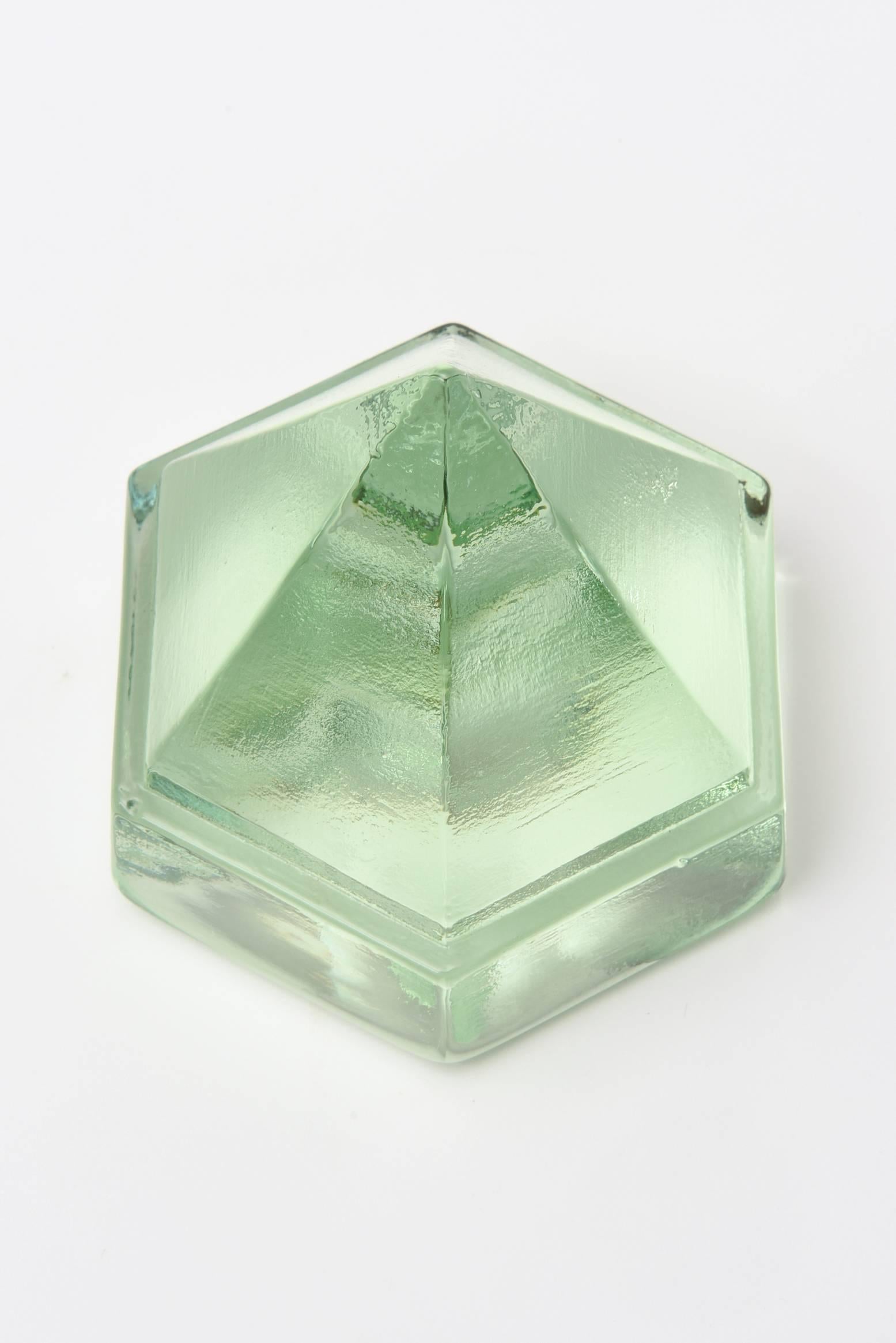 This lovely heavy glass object has pebbled or textured glass. It was used on a ship to beam light.
The mint green meets sage green takes on different hues depending on the light.
It is more vibrant in depth of color in person.


