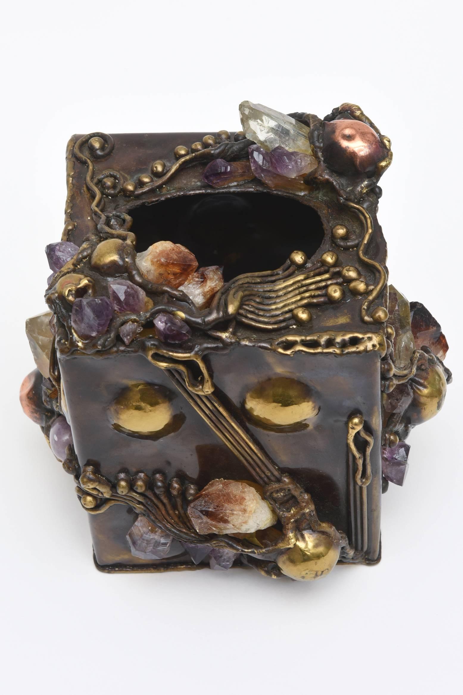 This amazing Brazilian one of a kind Kleenex box is a work of art. It is all handwrought and of the Brutalist nature. The metals are brass and copper mixed with protruding stones of quartz and amethyst. It is sculpture, for your tissues in your