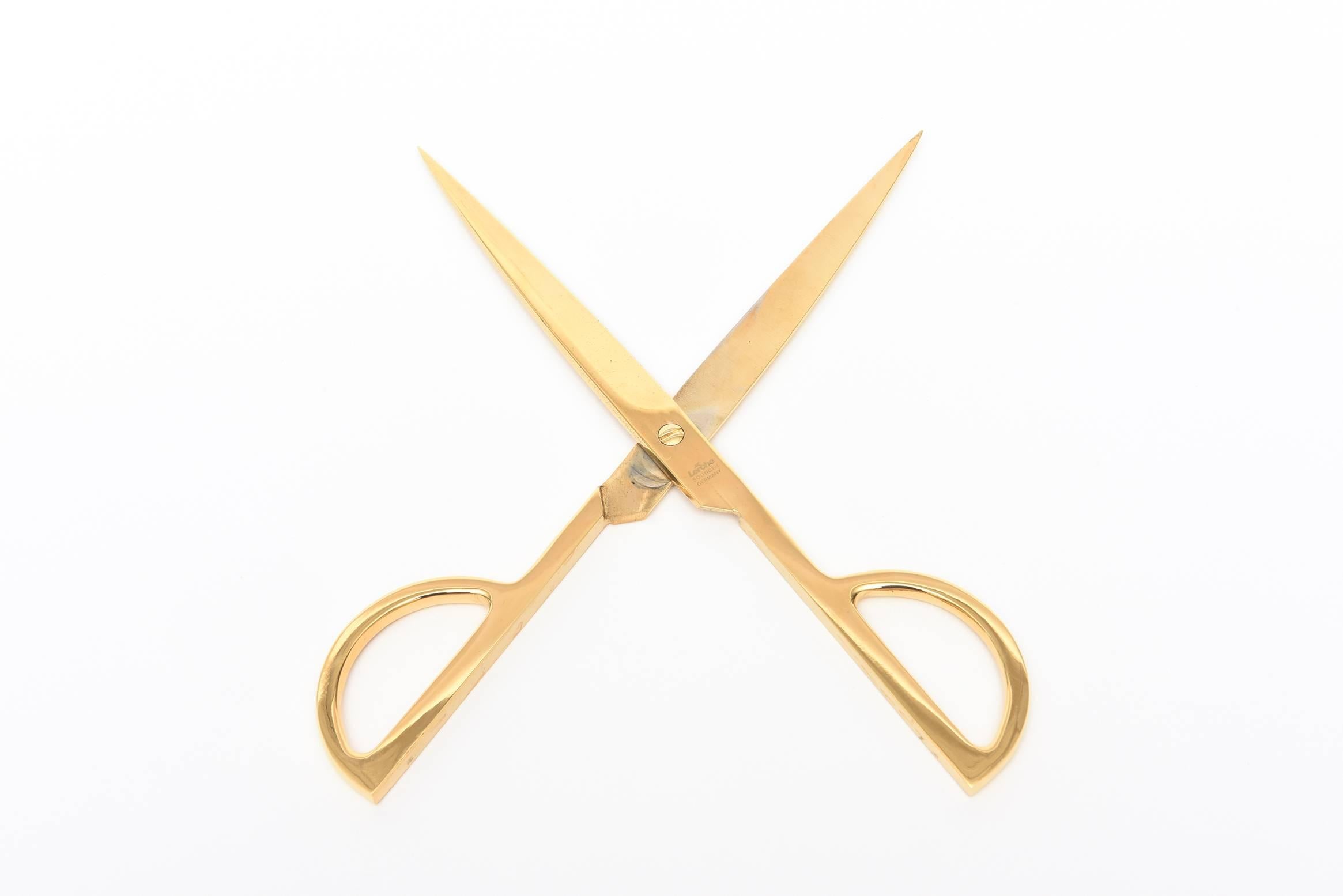 This fantastic vintage set of gold-plated steel modernist scissors and letter opener is signed Solingen.
It comes with its original black hard leather case that fits both pieces.
It is timeless and handsome and Classic. The letter opener is 8.5