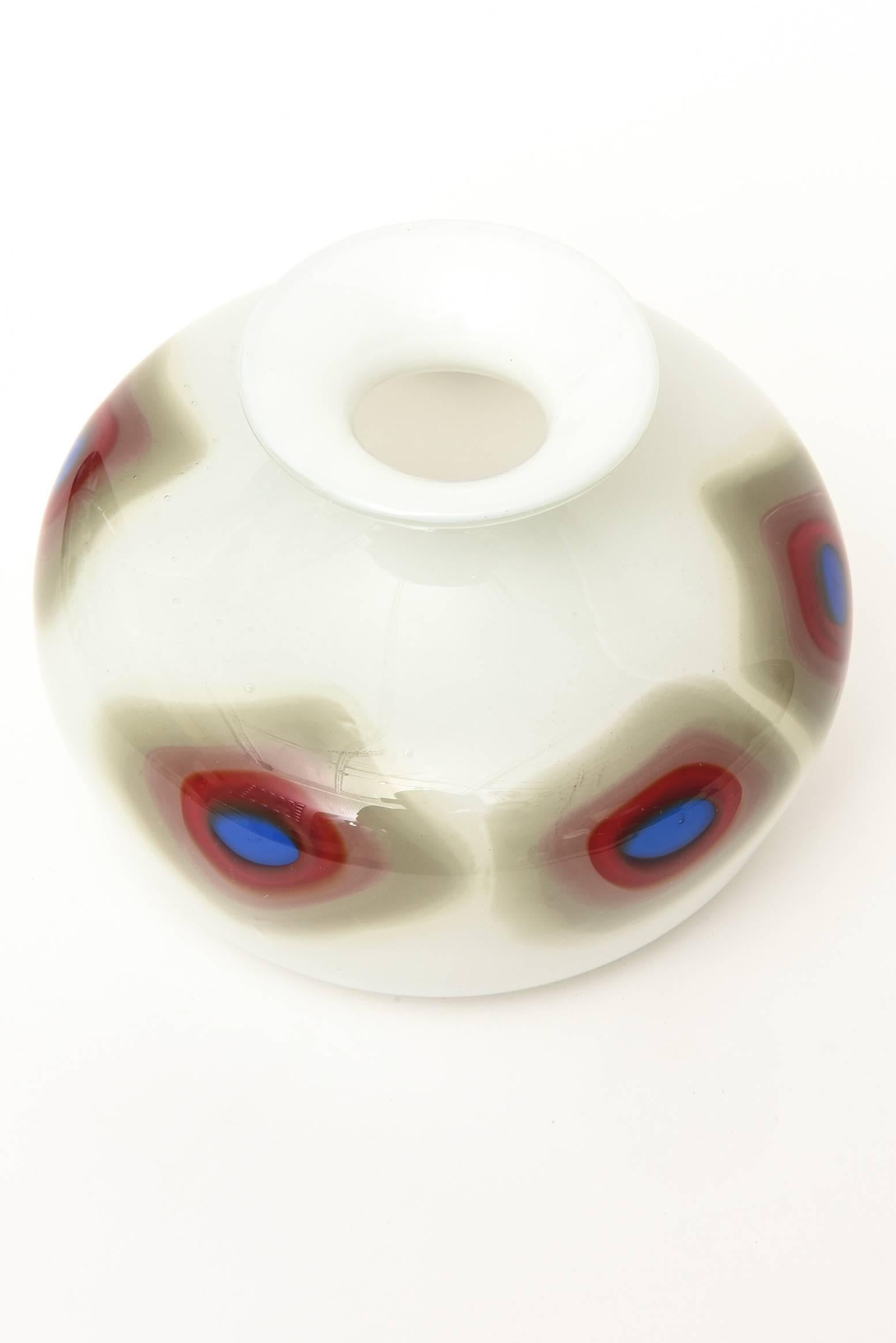 This graphic bullseye diamond pattern of this Italian Murano vase and or glass object stands alone as a great piece of glass. The white case glass is offset with a perimeter pattern of a diamond bullseye in colors that are radiants of gray that fade