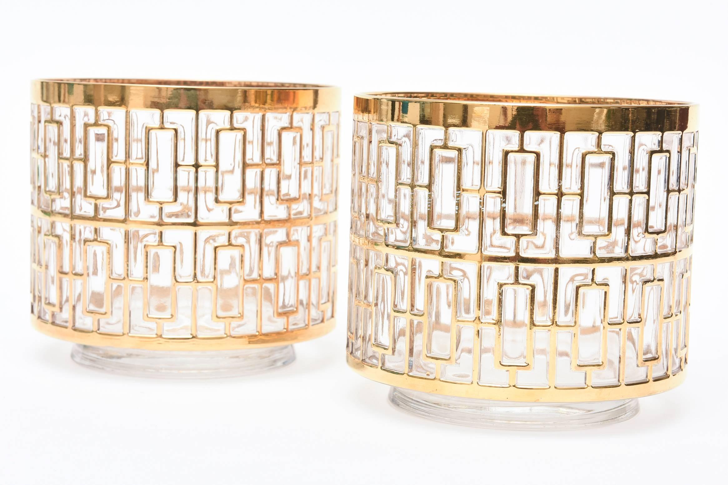 These pair of elegant period ice buckets are from the 1960s.  The pattern is a shoji screen/greek key. They are timeless.
The good plating is 24-carat gold overlay over clear glass and must be hand washed. Not safe for any dishwasher.
They can