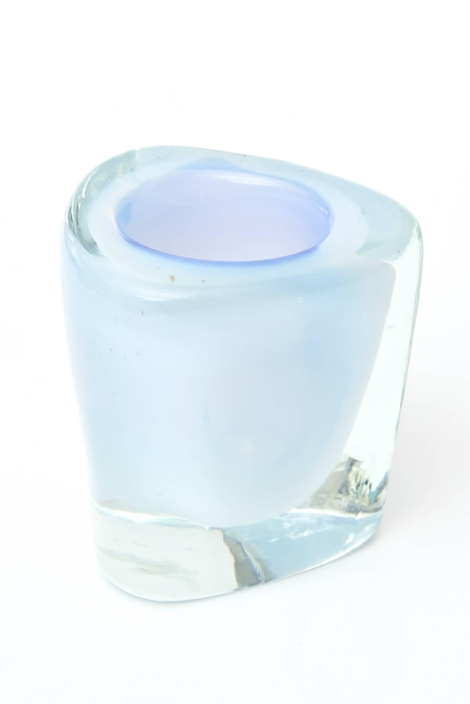 This beautiful and ethereal looking vintage Murano glass vessel is layered with opalescent Sommerso glass and bordered on top with a blue rim.
It can be used for so many purposes one ladies makeup brushes or gardenias or roses or etc. It is a