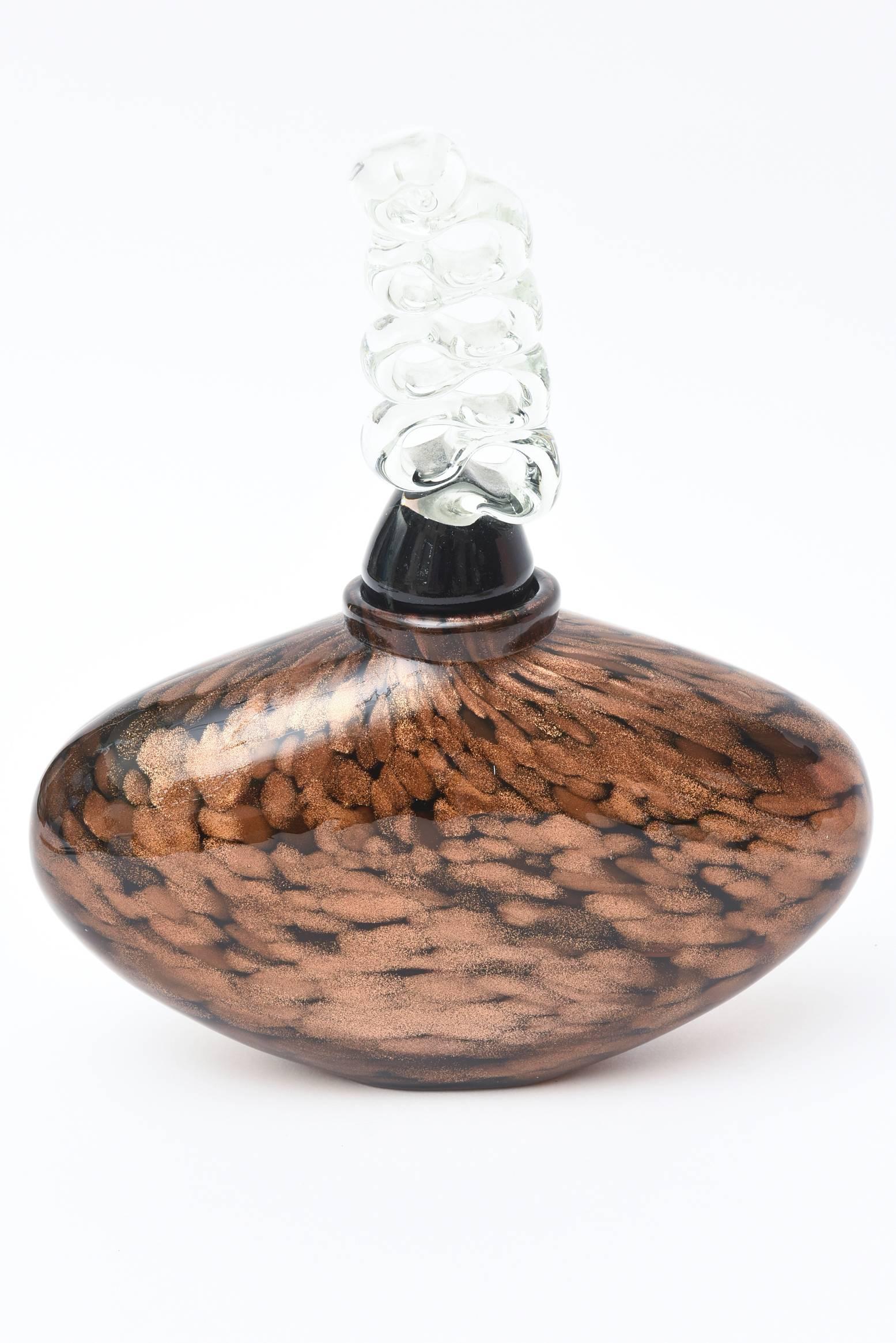 This stunning abstract design of this Italian monumental Murano glass oval decanter, perfume bottle or glass object has a fabulous sculptural original dramatic stopper. The base of the stopper is black glass with a twisted and sculptural clear glass